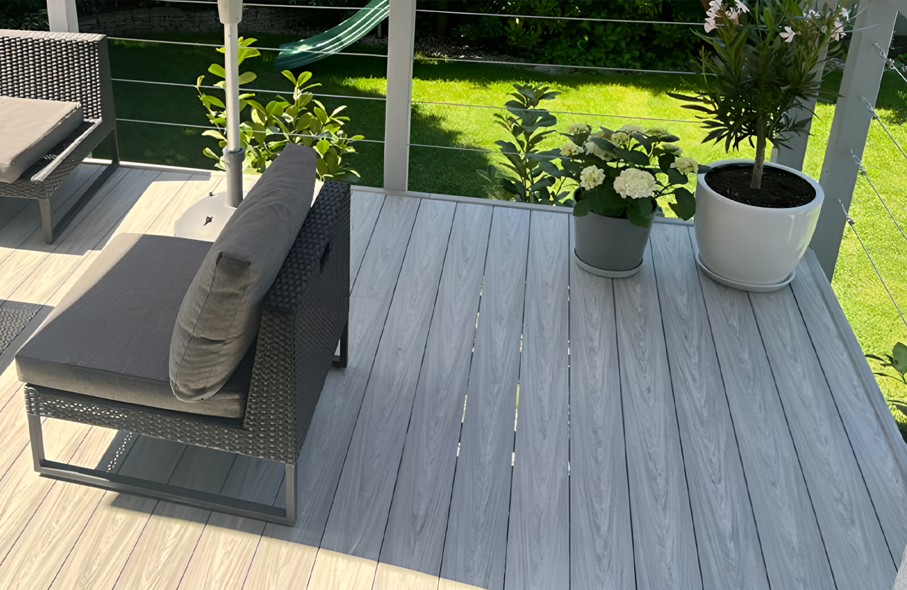 Modern garden terrace finished with BRUGGAN Multicolor grey decking boards and outdoor lounge furniture