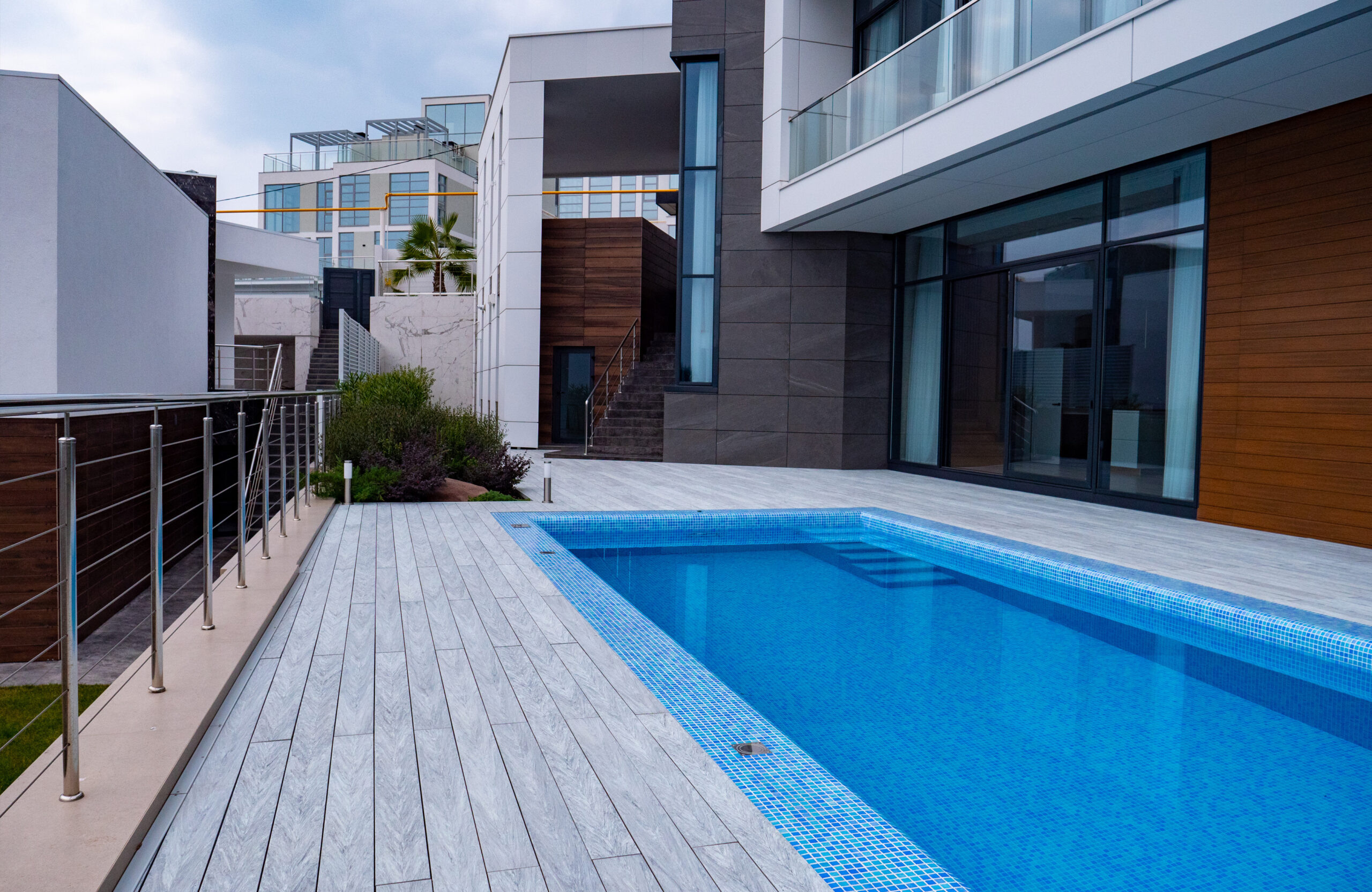 Bruggan Multicolor Grey composite decking around a modern outdoor swimming pool