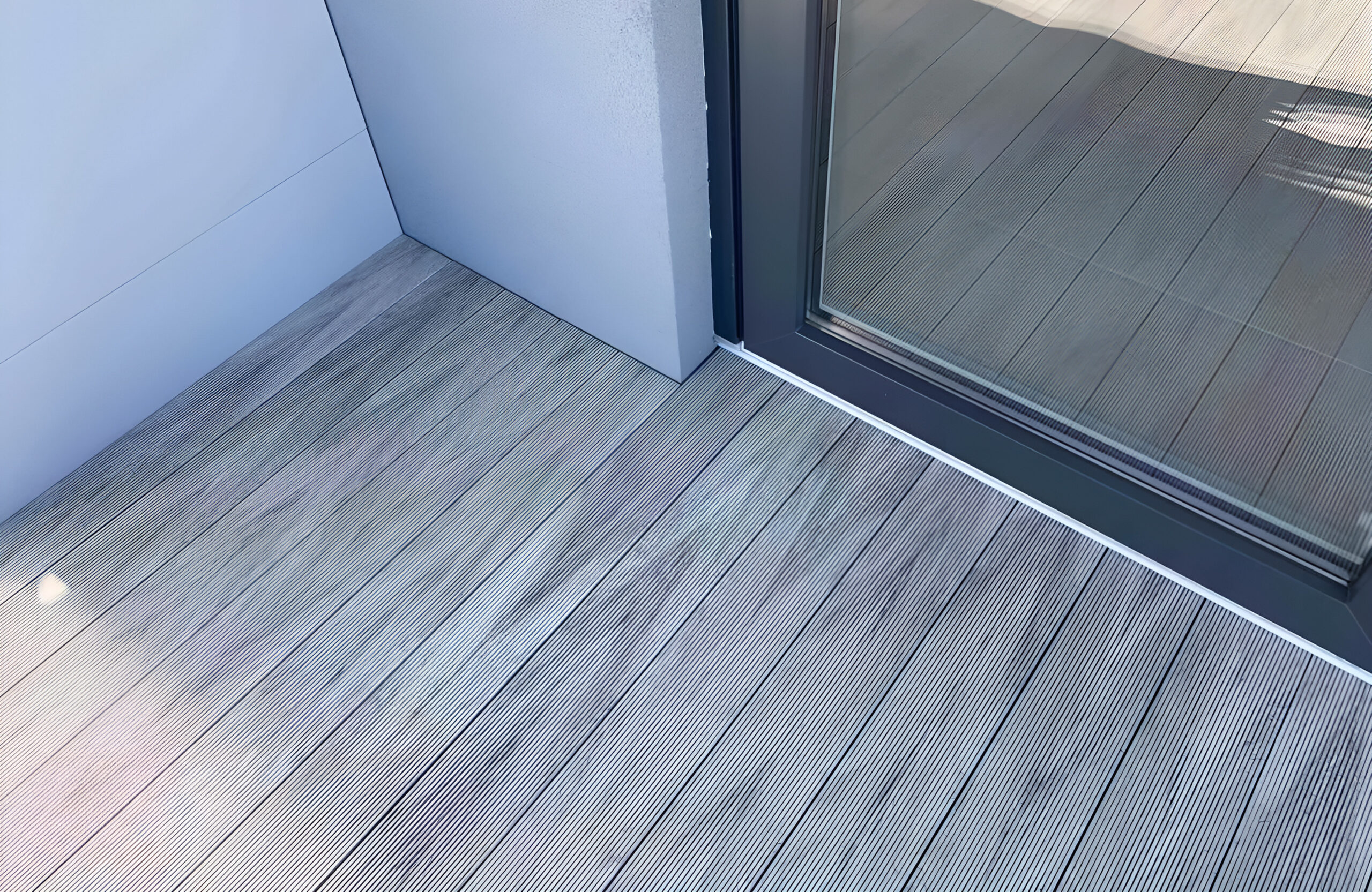 Stylish urban rooftop terrace featuring BRUGGAN Multicolor grey composite decking and modern outdoor design