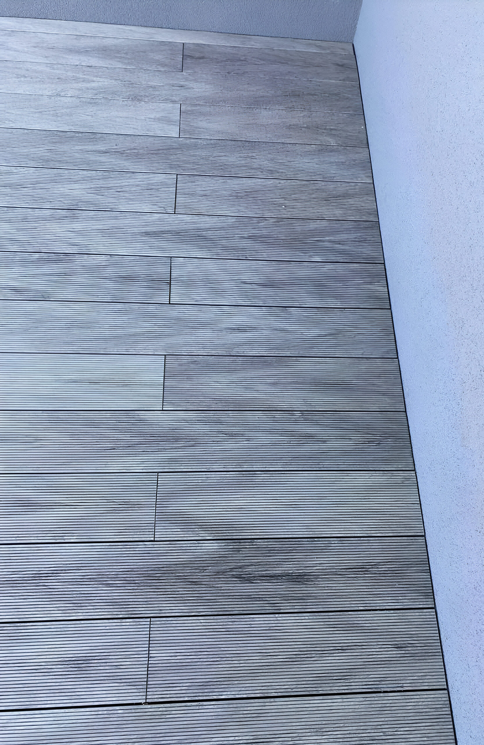 Stylish urban rooftop terrace featuring BRUGGAN Multicolor grey composite decking and modern outdoor design