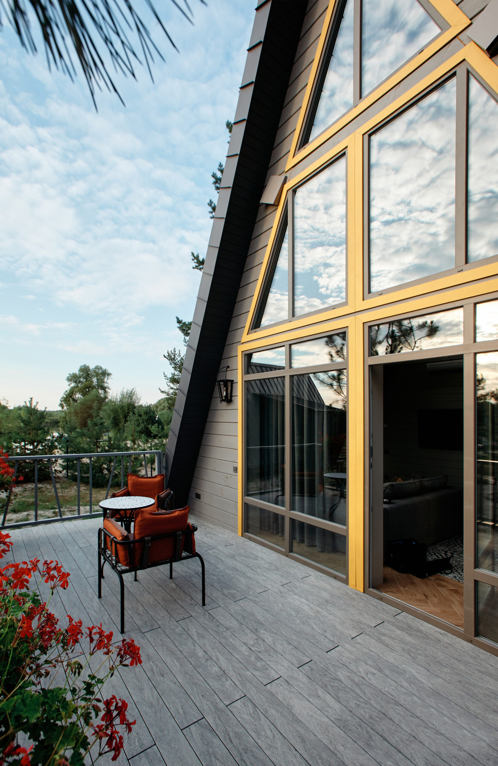 Grey BRUGGAN Multicolor composite decking on a modern outdoor terrace surrounded by pine trees