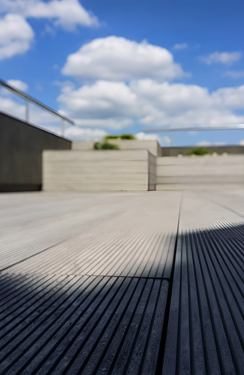 Stylish urban rooftop terrace featuring BRUGGAN Multicolor grey composite decking and modern outdoor design