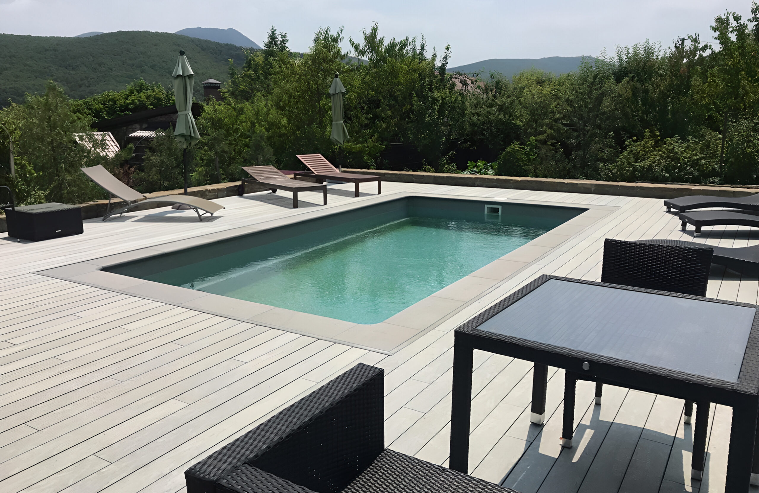 Grey BRUGGAN Multicolor decking for a stylish outdoor pool area