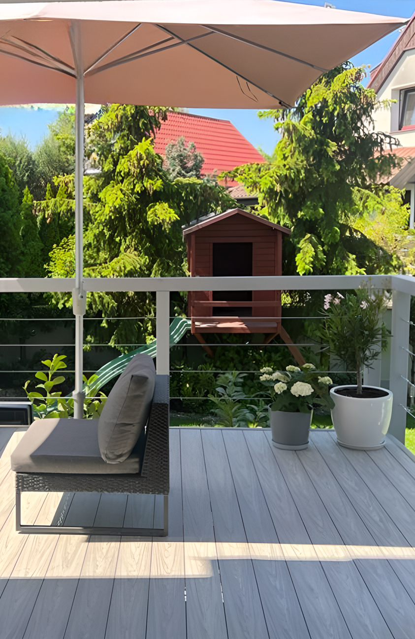 Modern garden terrace finished with BRUGGAN Multicolor grey decking boards and outdoor lounge furniture