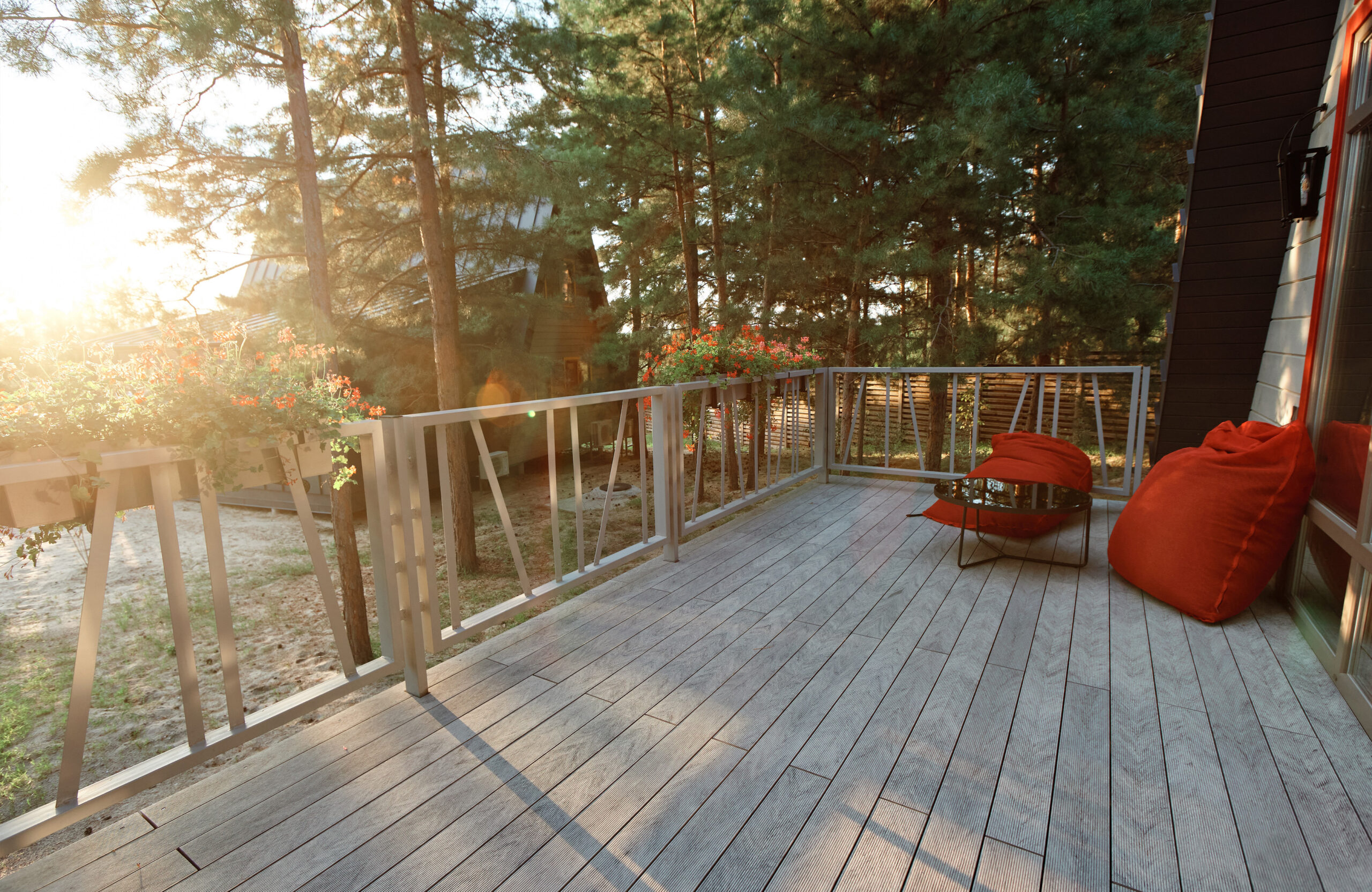 Grey BRUGGAN Multicolor composite decking on a modern outdoor terrace surrounded by pine trees