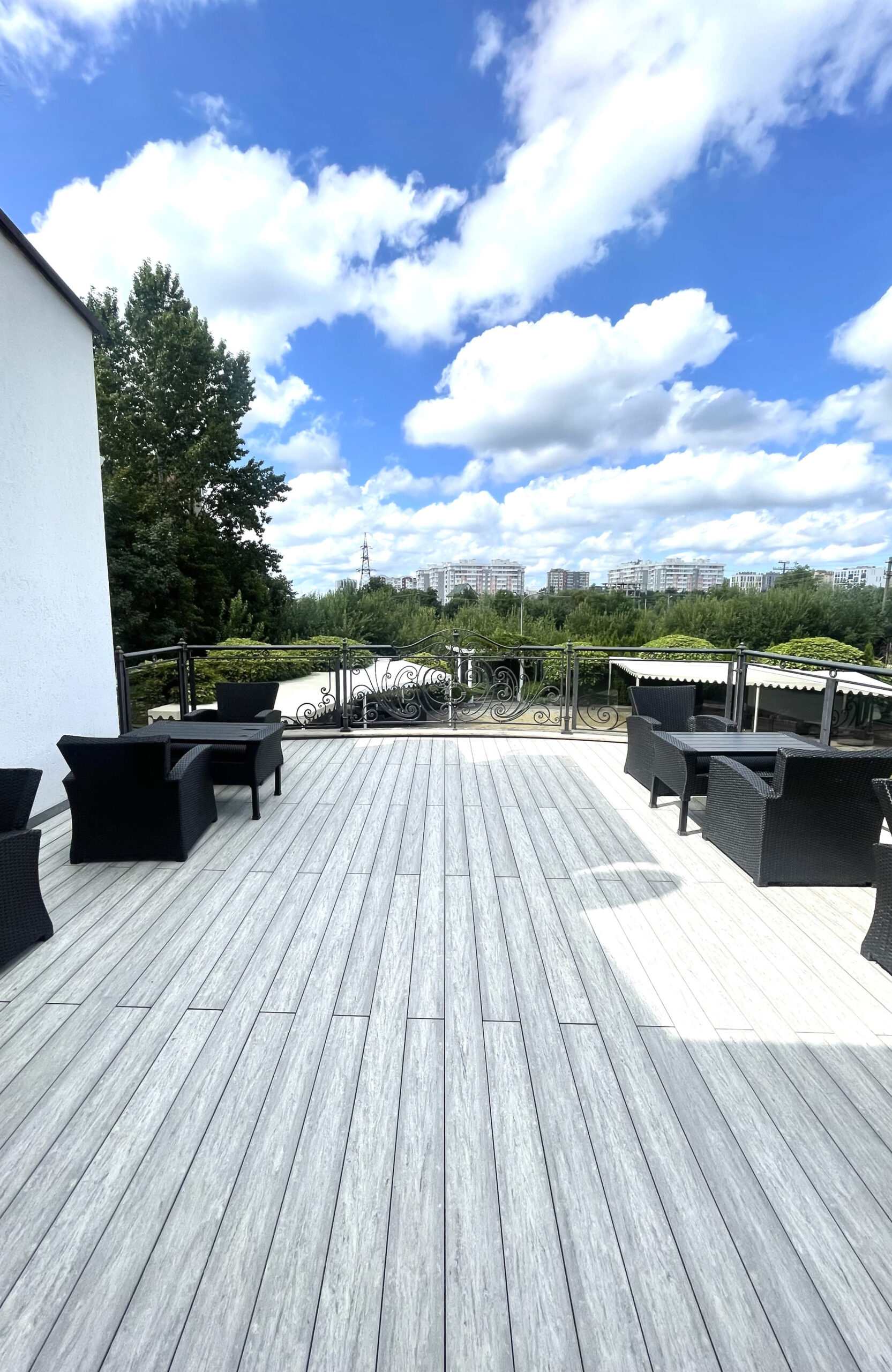 BRUGGAN MultiColor Grey composite decking on an outdoor restaurant terrace with panoramic city views