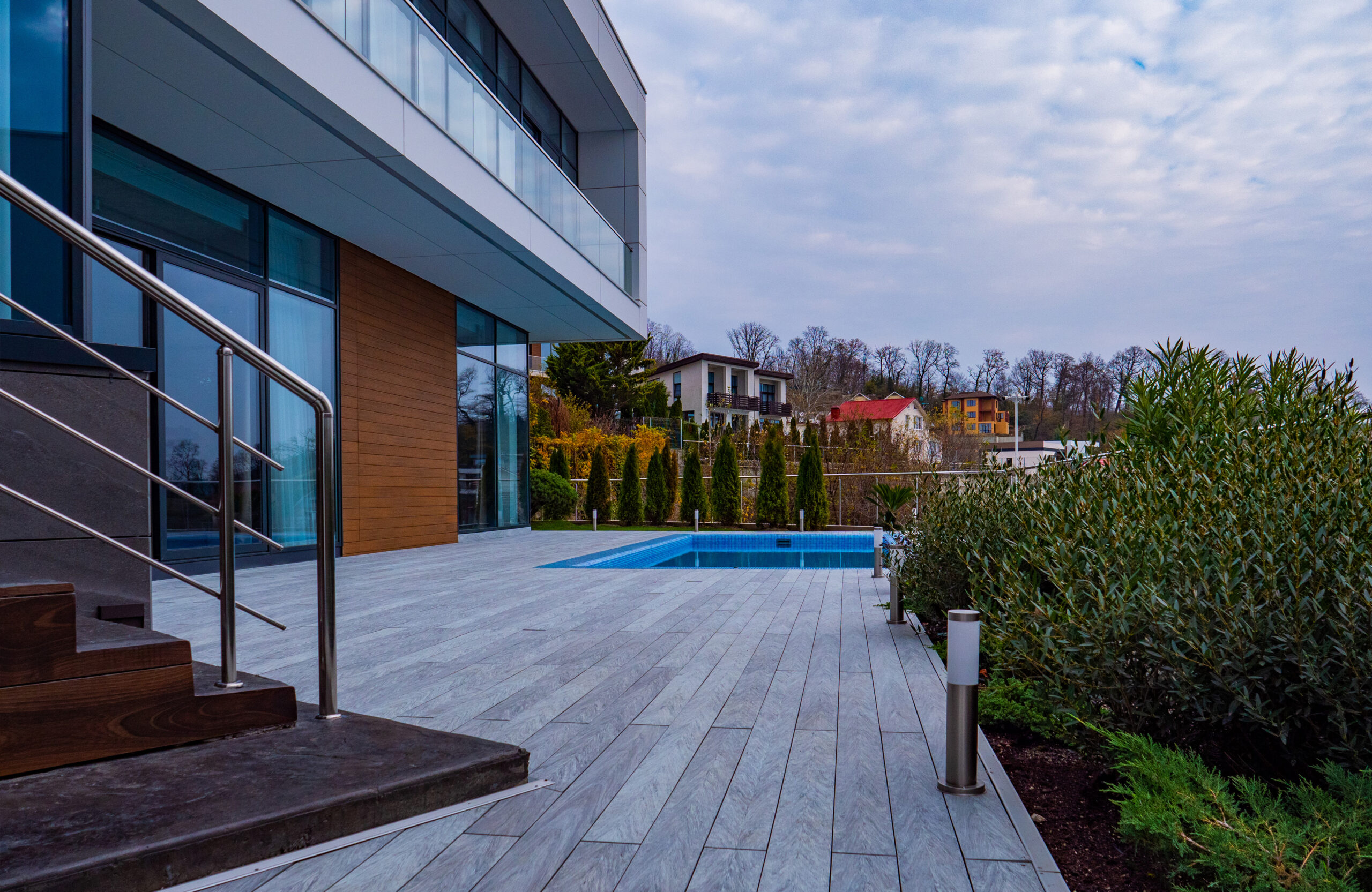 Bruggan Multicolor Grey pool deck at a contemporary house with glass railings