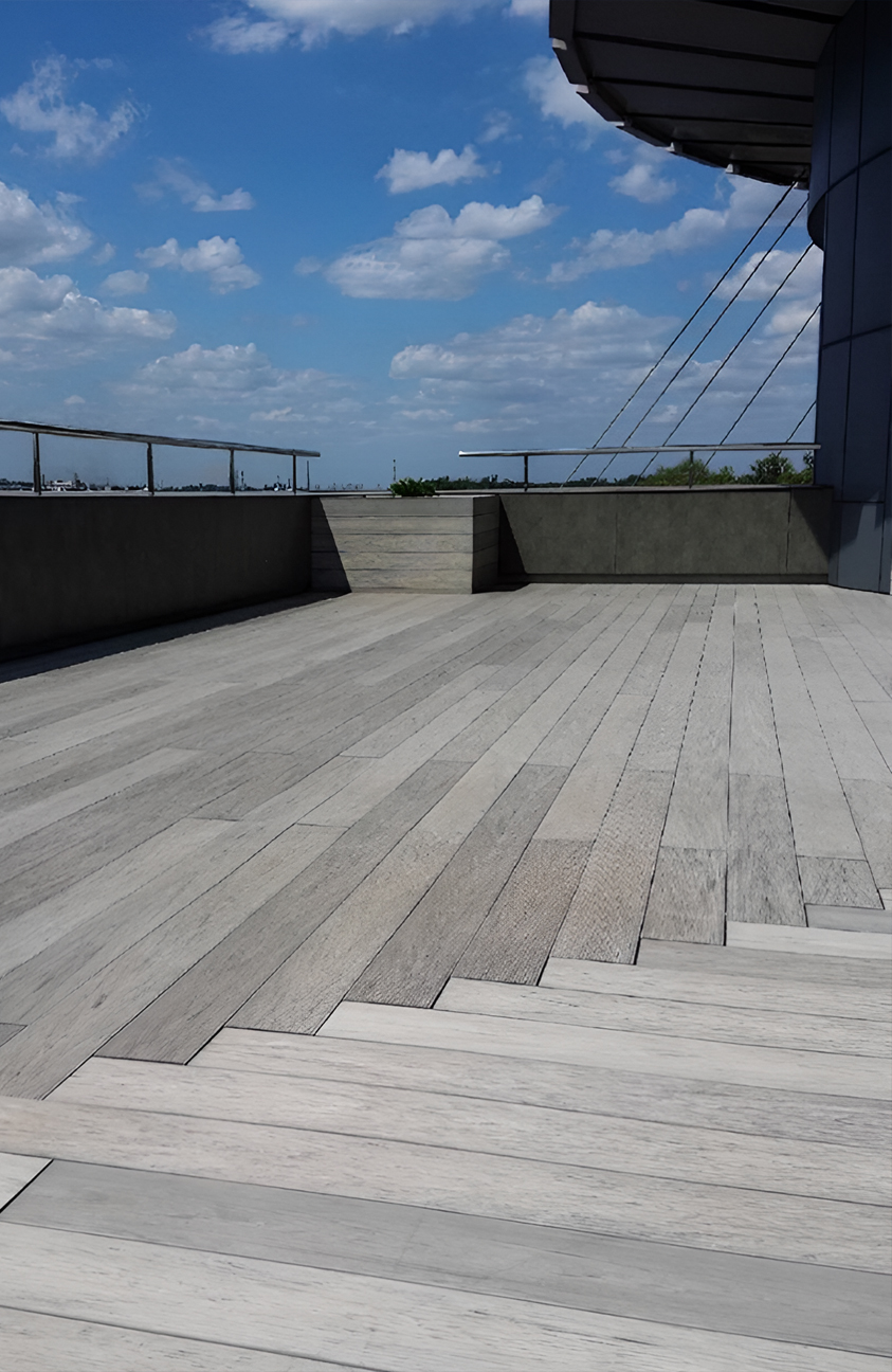 Stylish urban rooftop terrace featuring BRUGGAN Multicolor grey composite decking and modern outdoor design