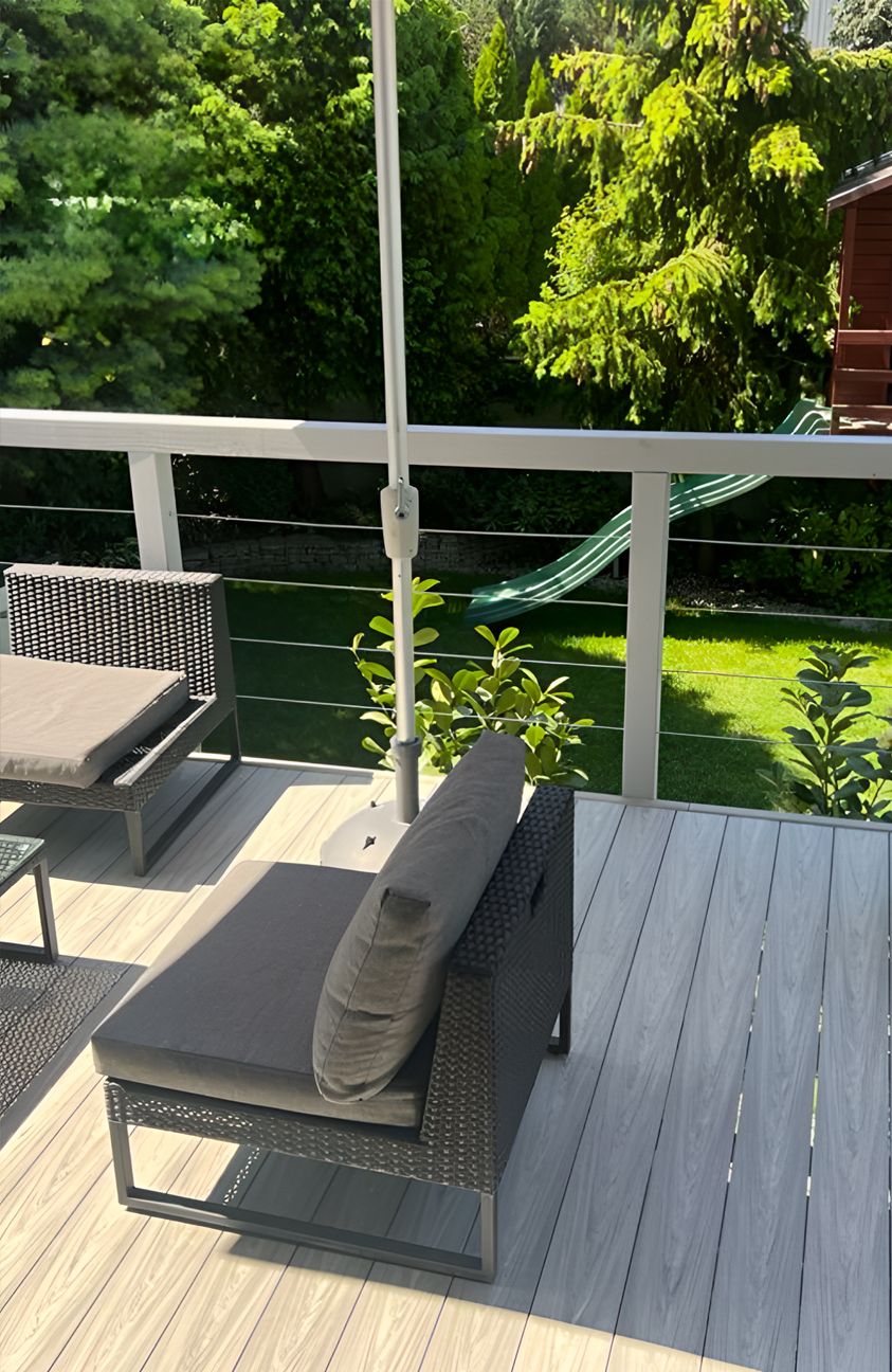 Modern garden terrace finished with BRUGGAN Multicolor grey decking boards and outdoor lounge furniture