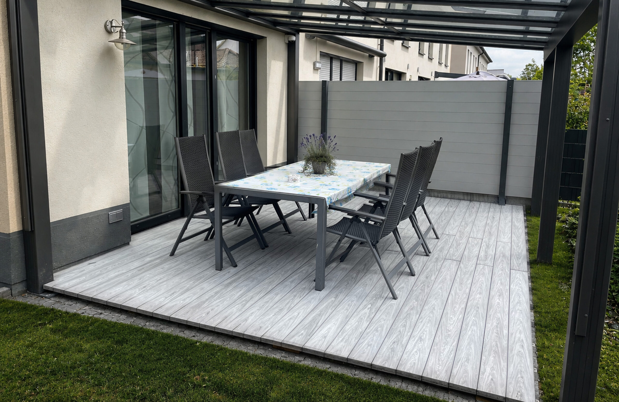 BRUGGAN Multicolor grey composite decking on a modern residential terrace with outdoor furniture