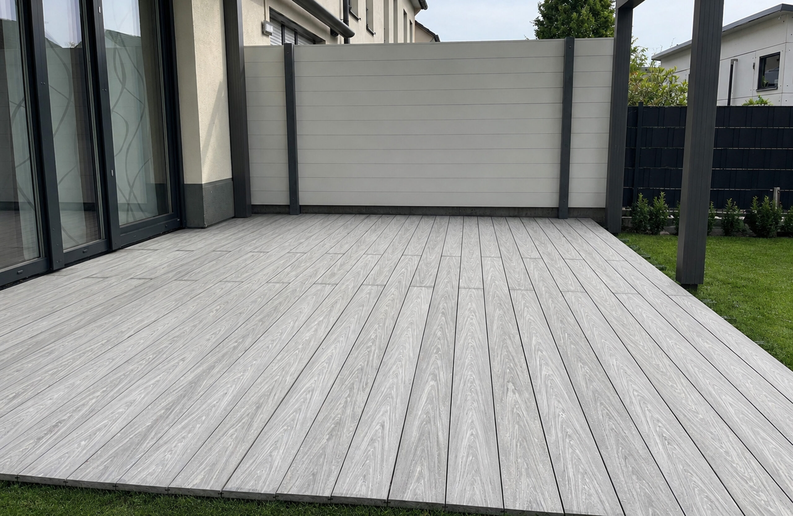 BRUGGAN Multicolor grey composite decking on a modern residential terrace with outdoor furniture