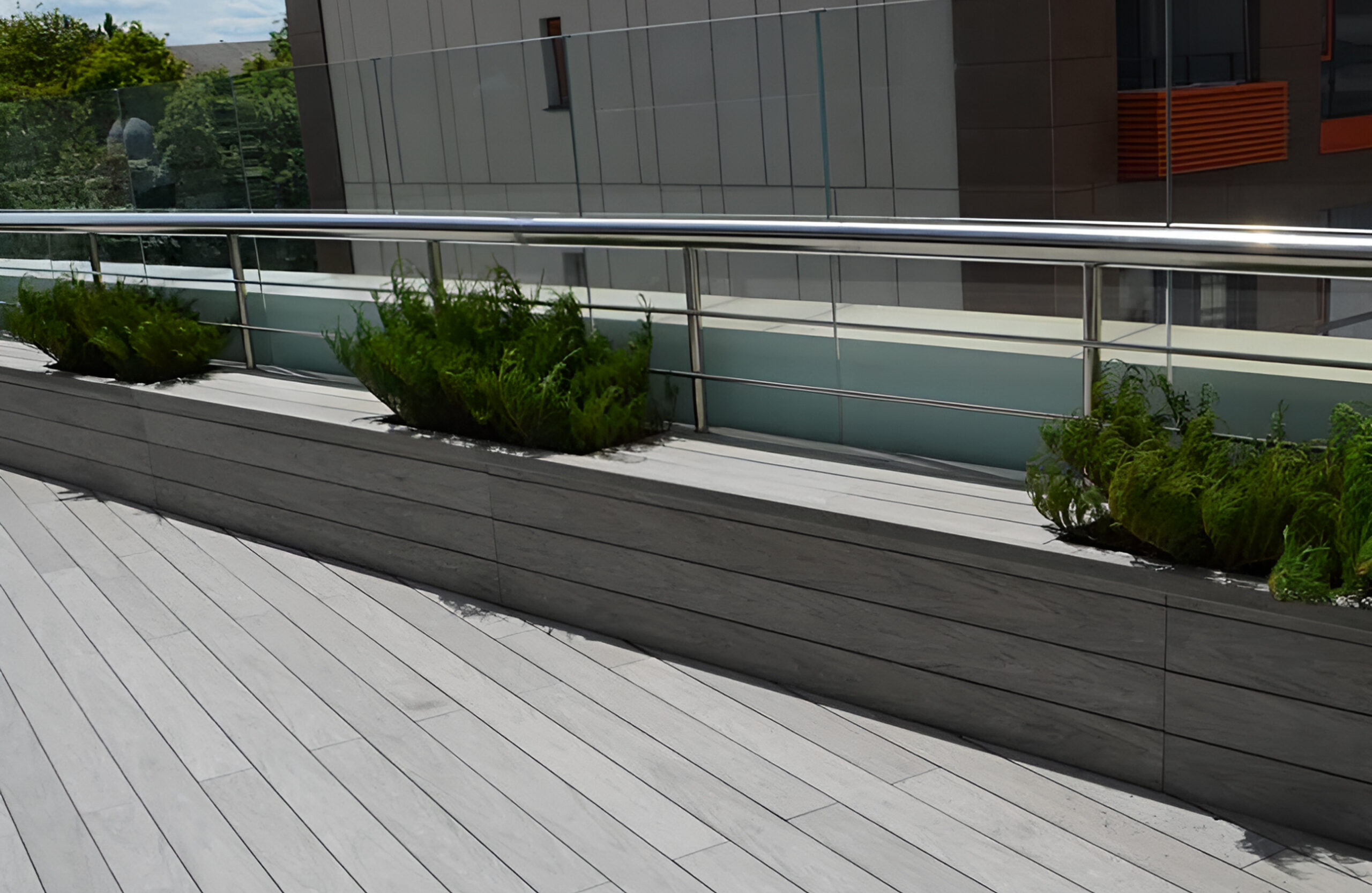 Stylish urban rooftop terrace featuring BRUGGAN Multicolor grey composite decking and modern outdoor design
