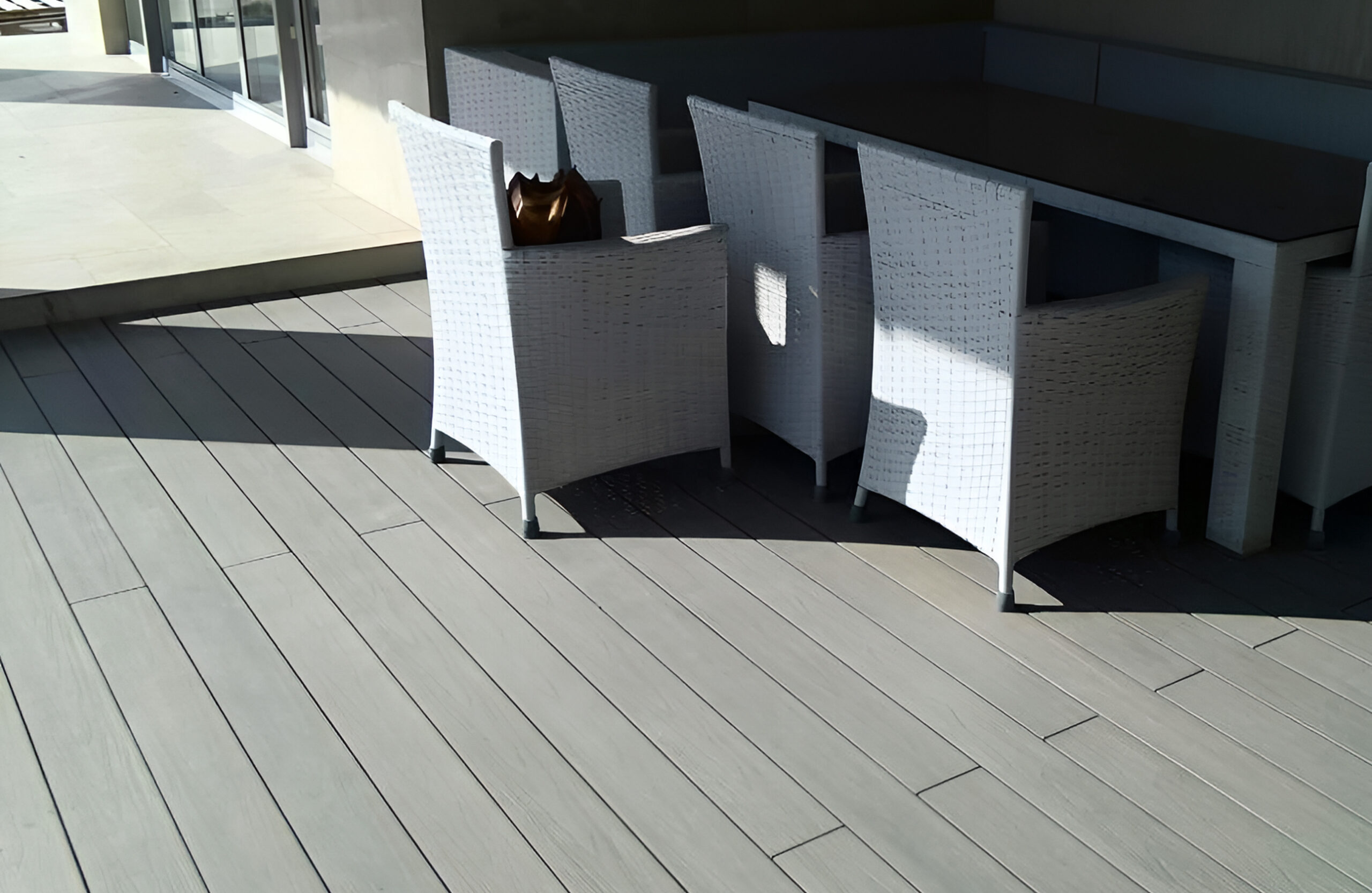 Stylish urban rooftop terrace featuring BRUGGAN Multicolor grey composite decking and modern outdoor design