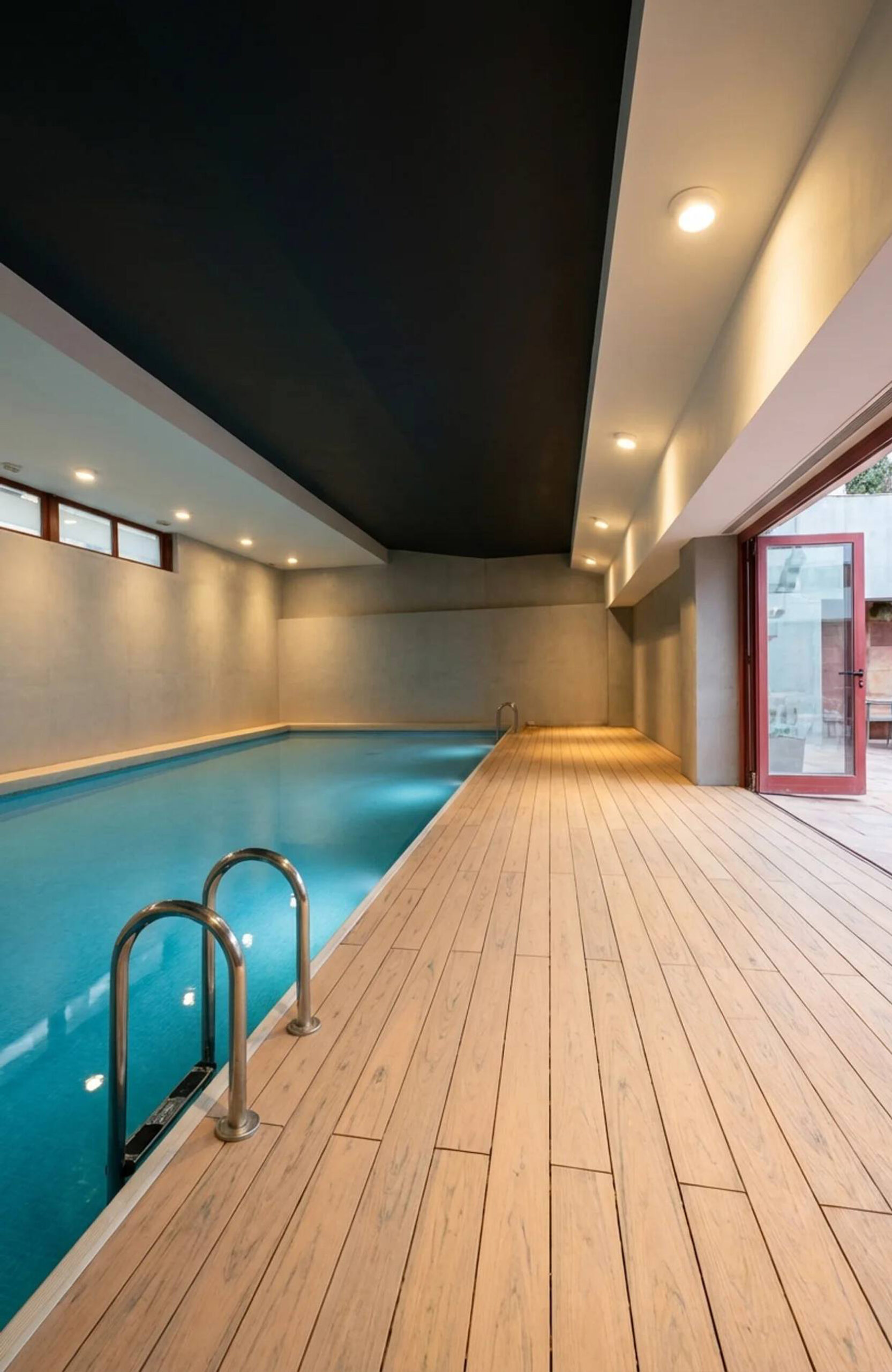 Indoor pool area finished with BRUGGAN Multicolor composite decking in sand color.