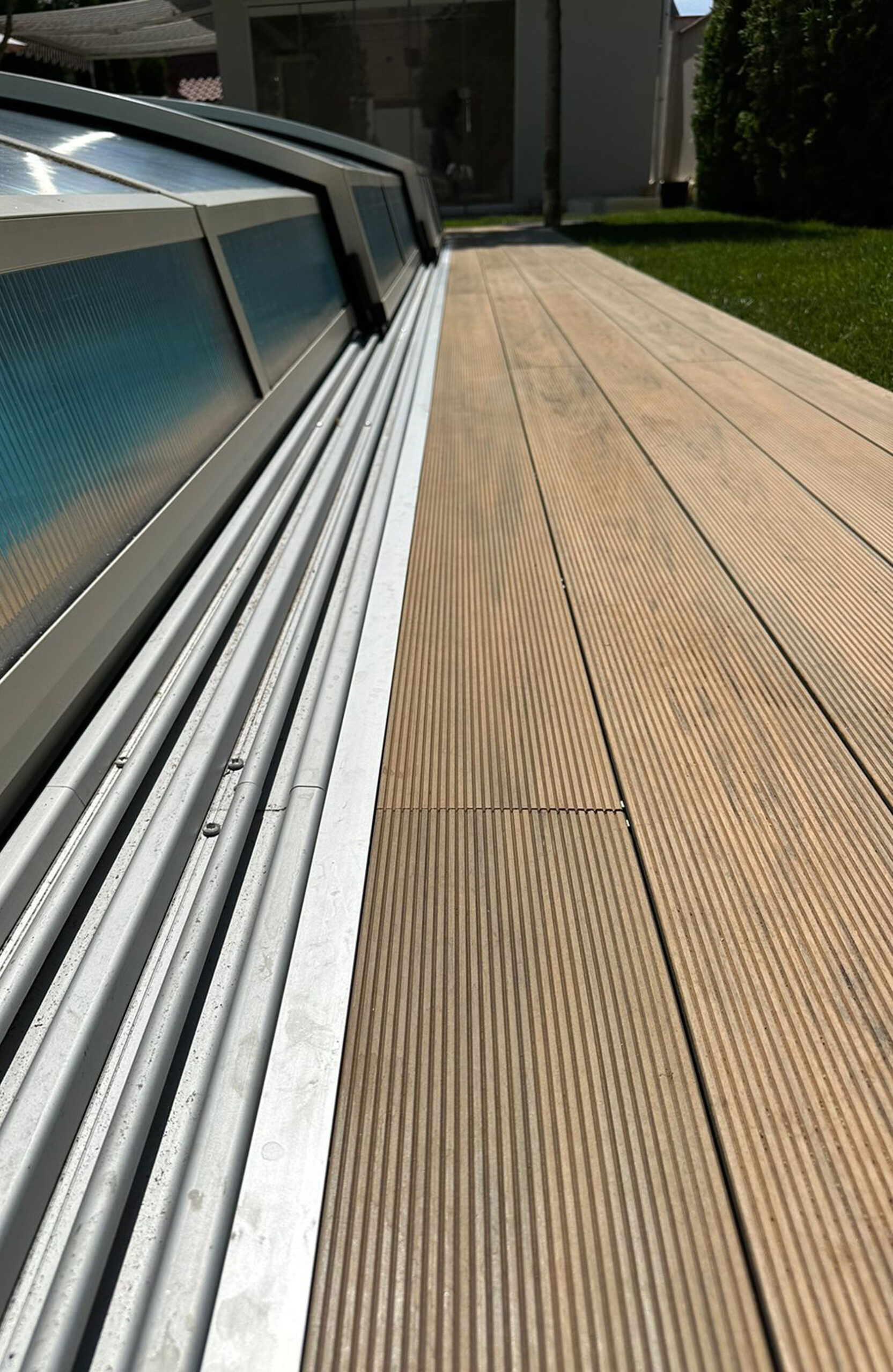 Outdoor pool area finished with BRUGGAN Multicolor decking in sand color