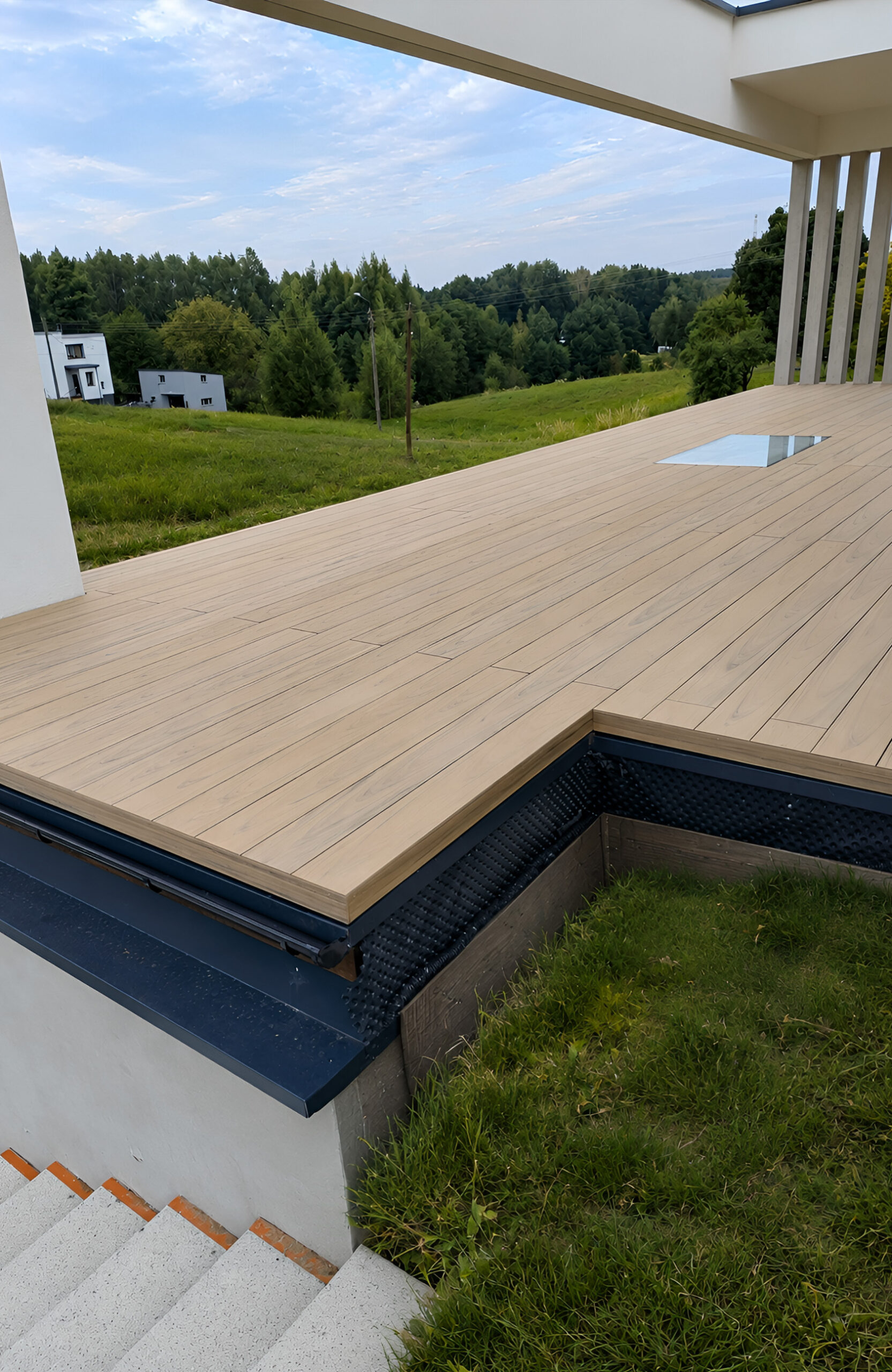 BRUGGAN Multicolor Sand WPC decking with natural wood grain on a contemporary home terrace