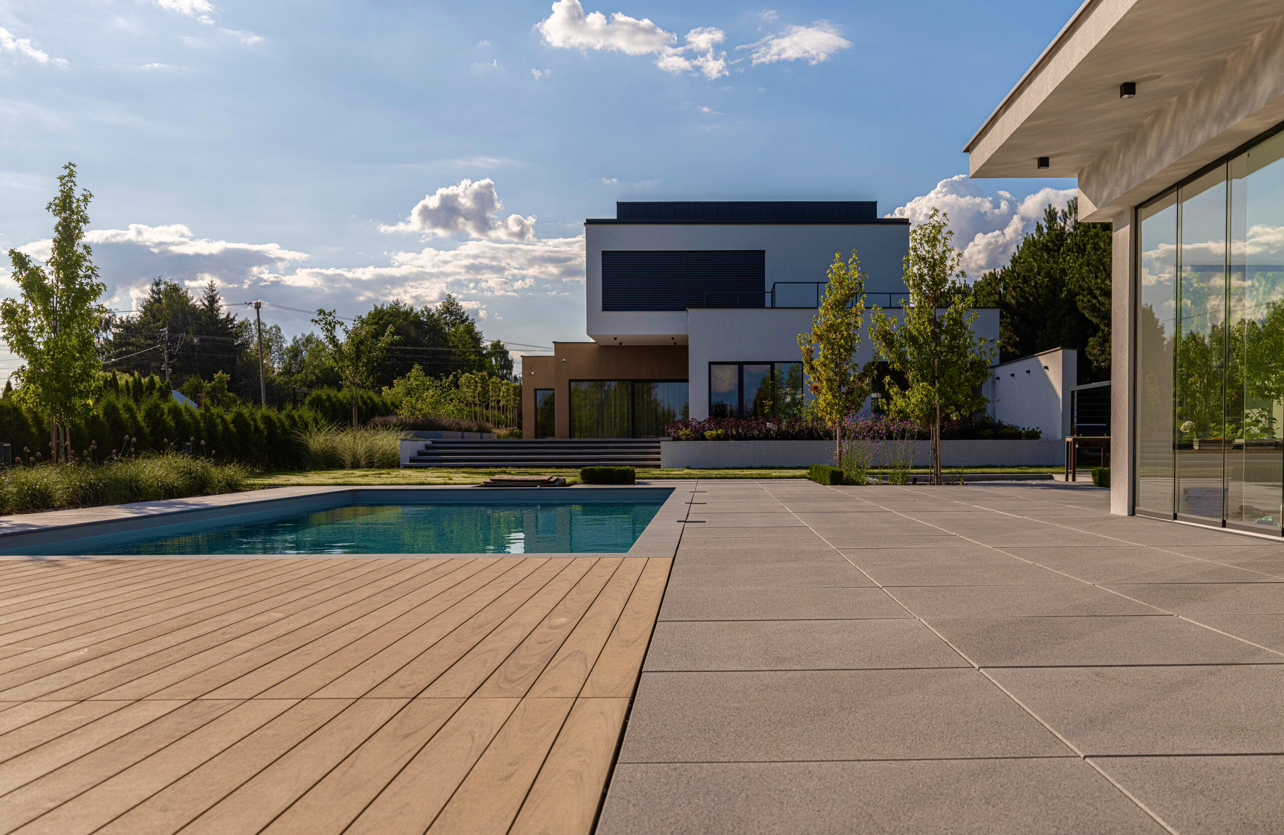 Modern outdoor terrace and pool area finished with BRUGGAN Multicolor sand decking