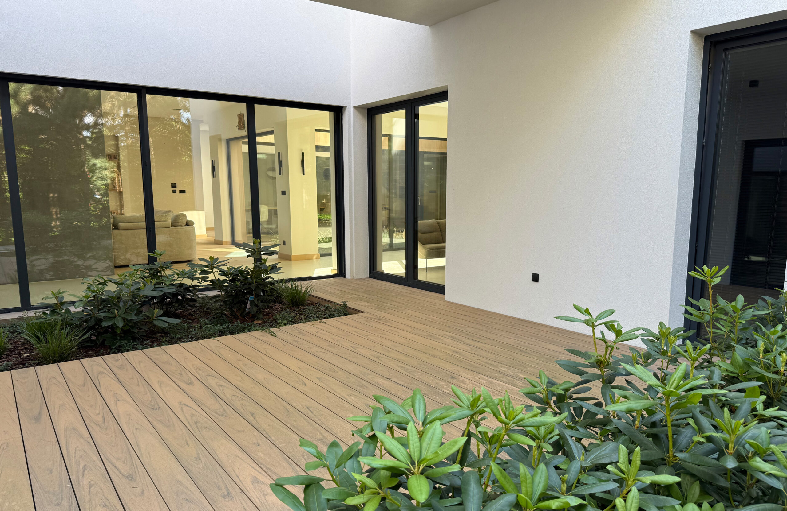 Modern outdoor terrace and pool area finished with BRUGGAN Multicolor sand decking