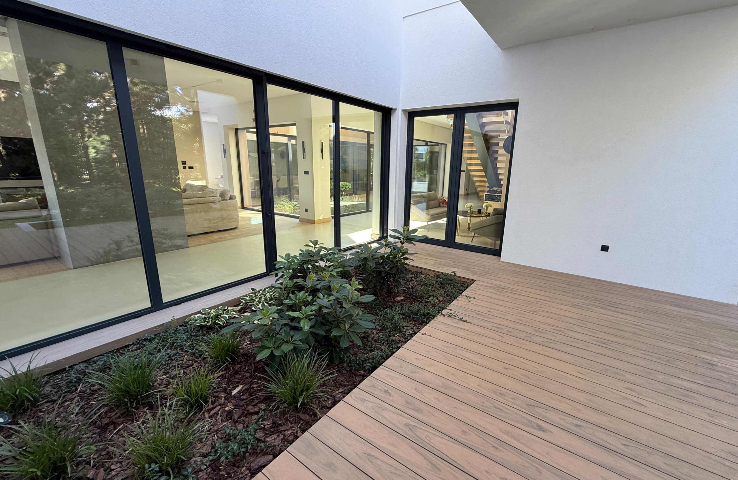 Modern outdoor terrace and pool area finished with BRUGGAN Multicolor sand decking