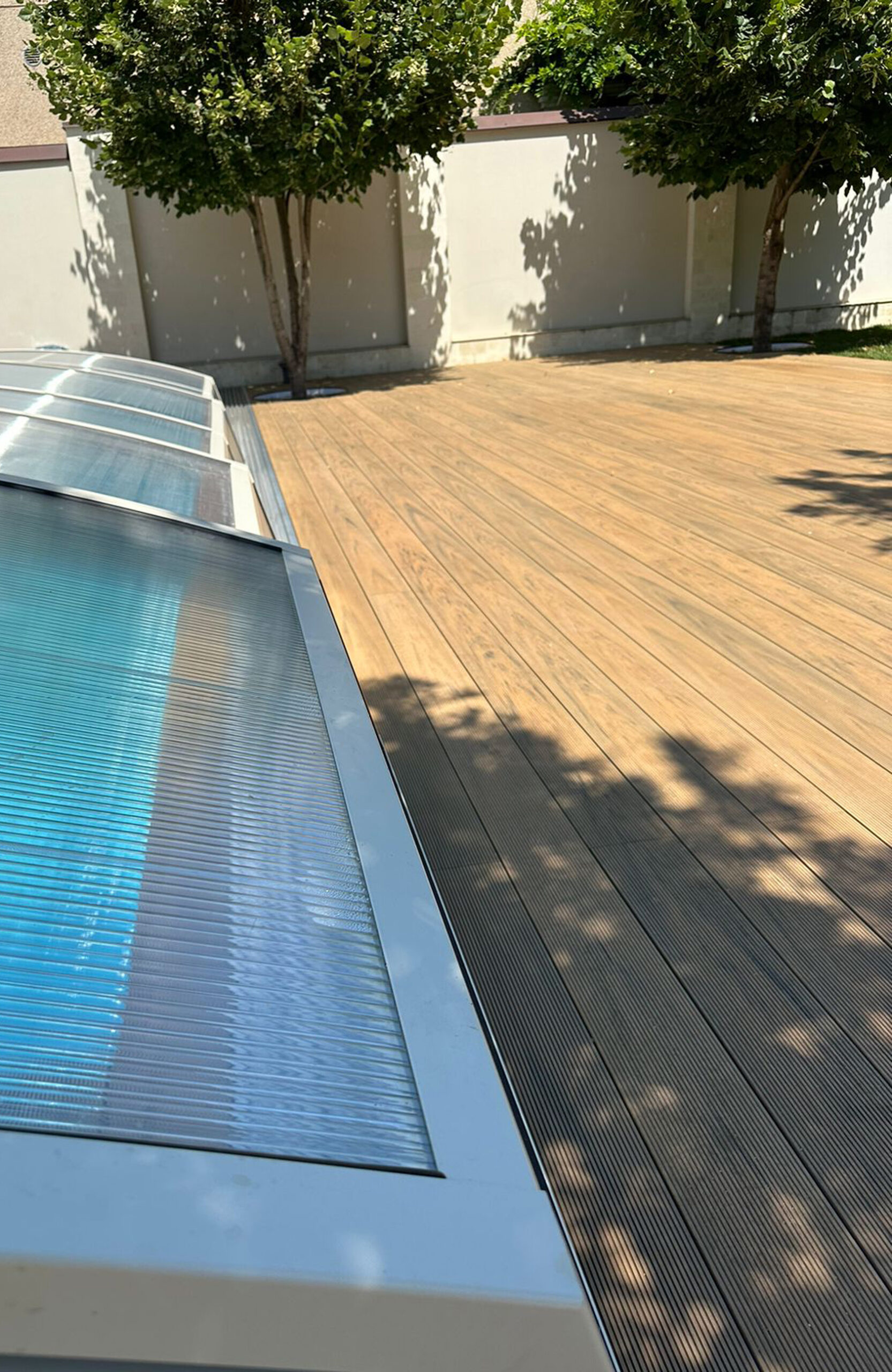 Outdoor pool area finished with BRUGGAN Multicolor decking in sand color