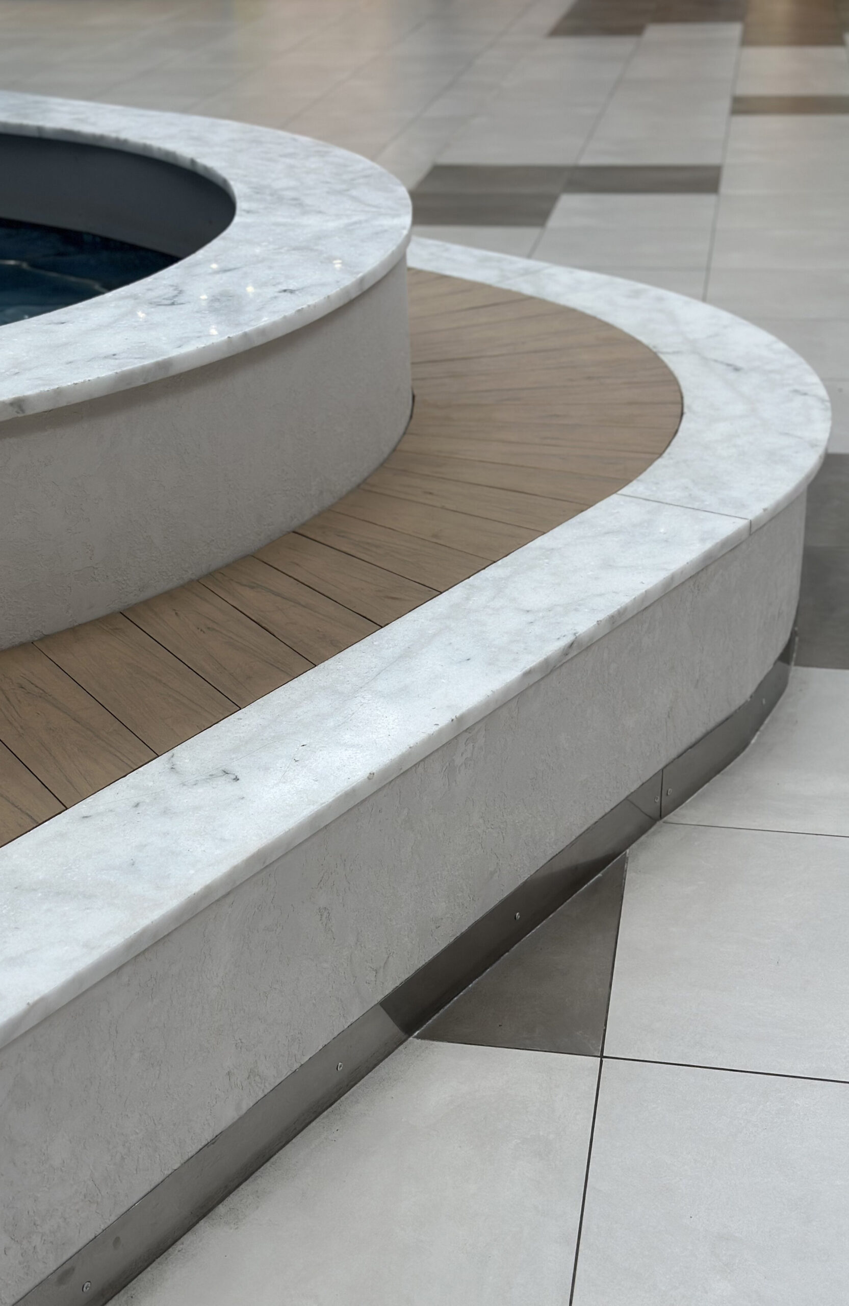 BRUGGAN Multicolor Sand WPC decking used for a curved fountain area in a shopping mall