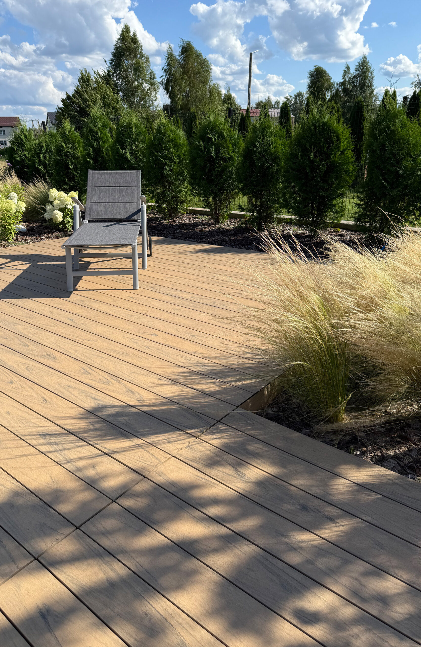 Modern outdoor terrace and pool area finished with BRUGGAN Multicolor sand decking