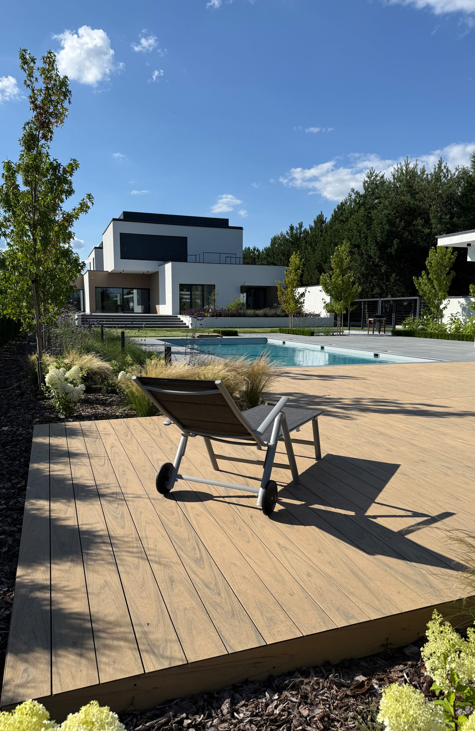 Modern outdoor terrace and pool area finished with BRUGGAN Multicolor sand decking