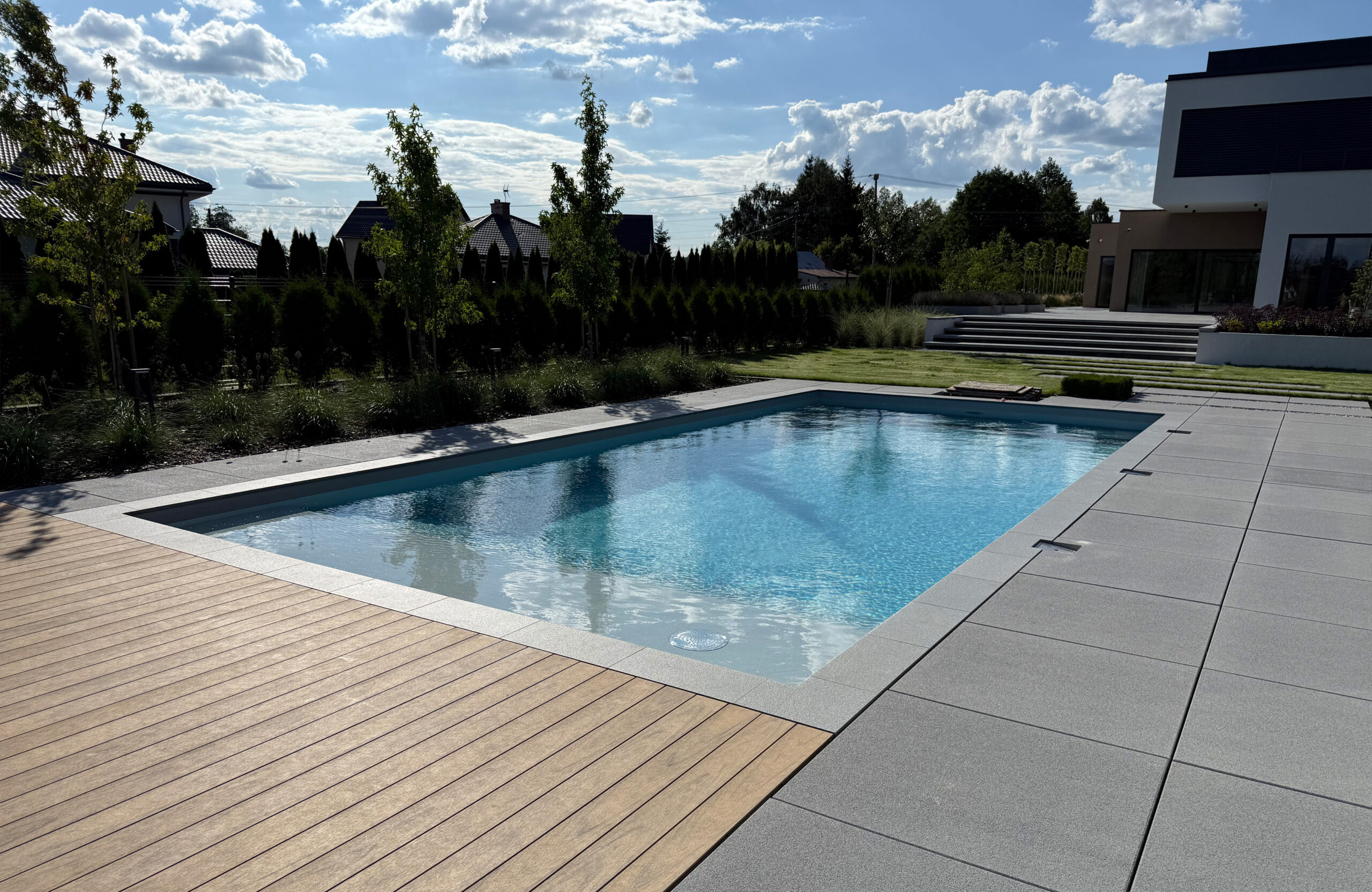 Modern outdoor terrace and pool area finished with BRUGGAN Multicolor sand decking