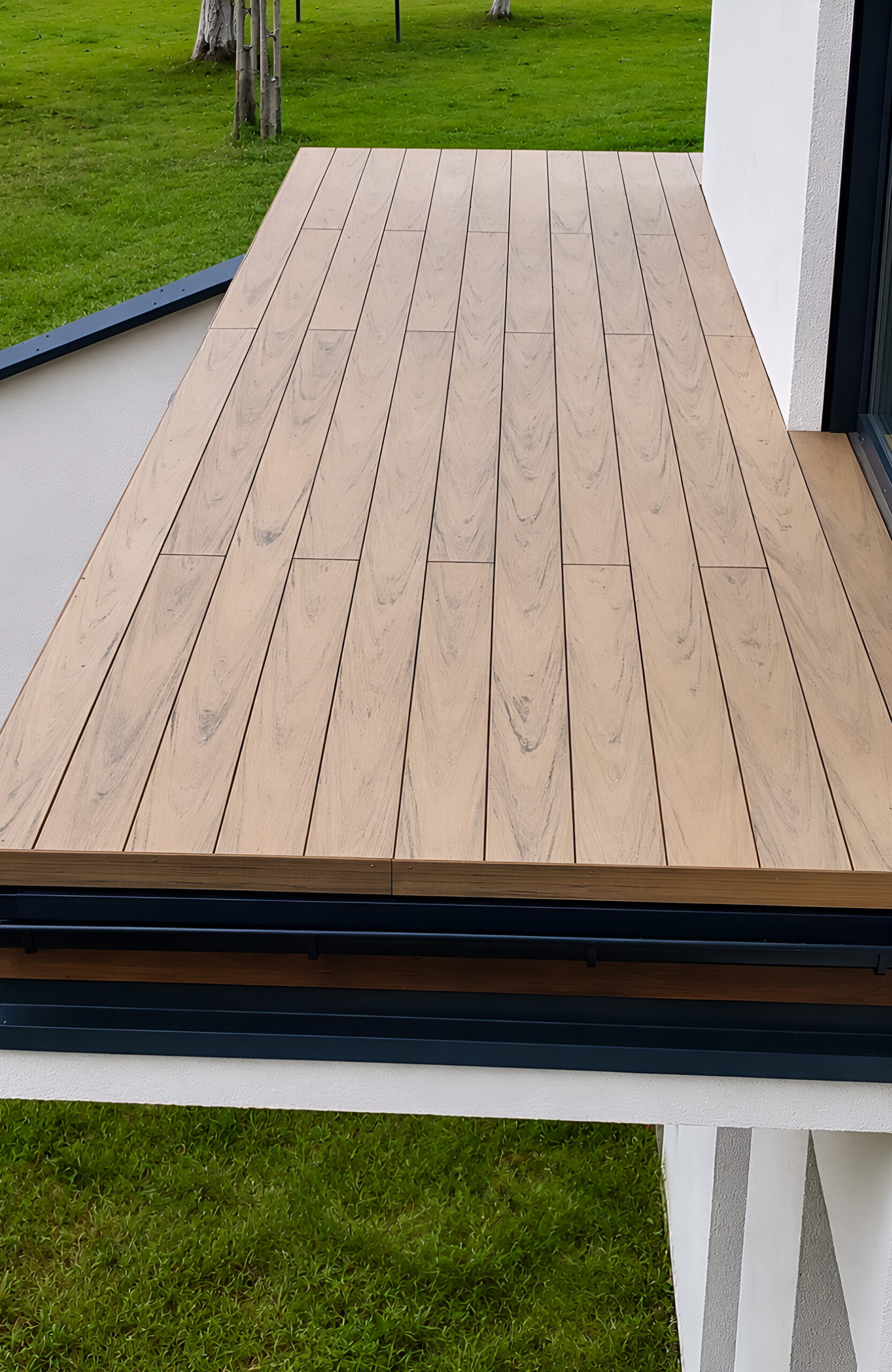 BRUGGAN Multicolor Sand WPC decking with natural wood grain on a contemporary home terrace