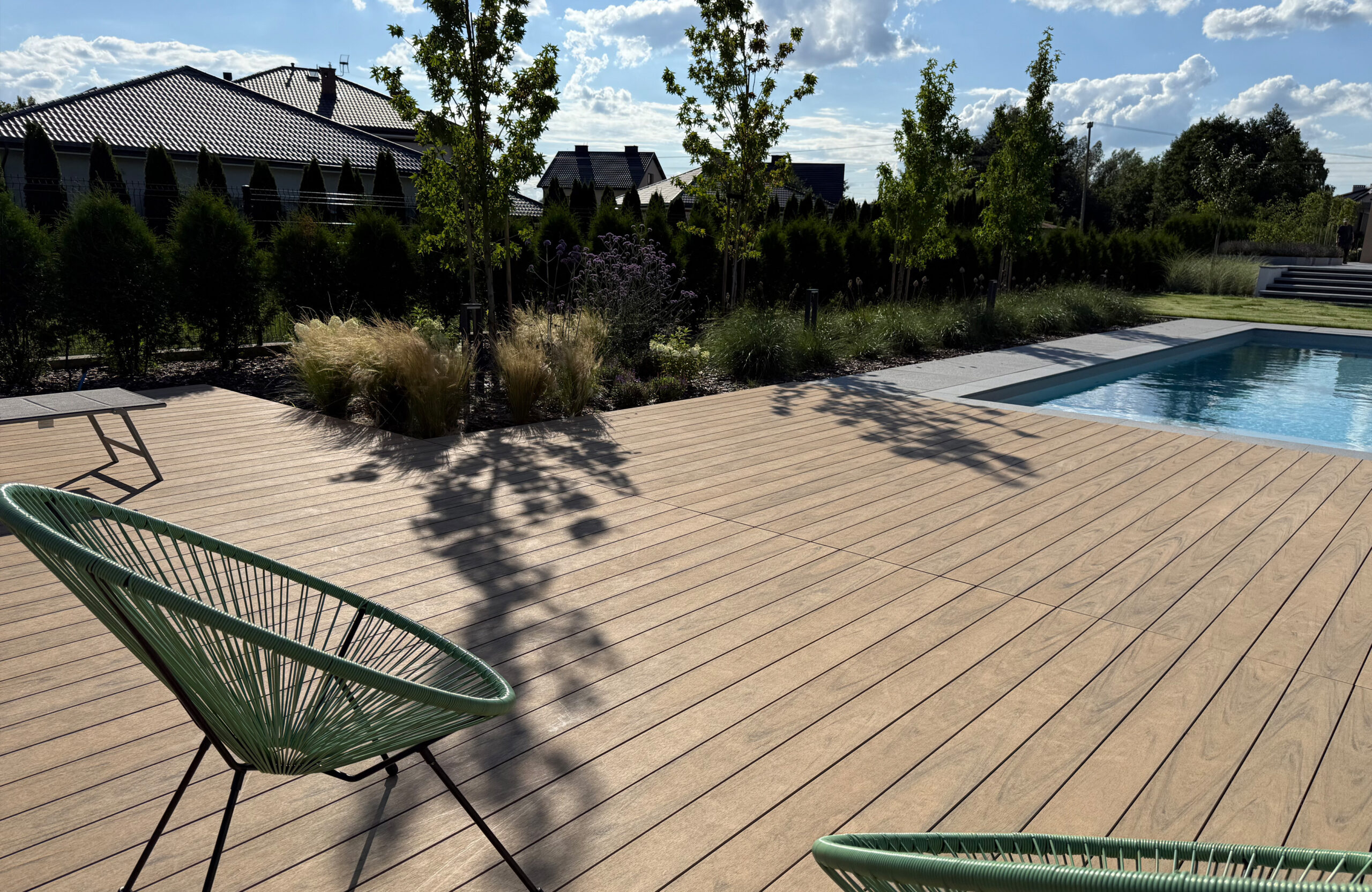 Modern outdoor terrace and pool area finished with BRUGGAN Multicolor sand decking