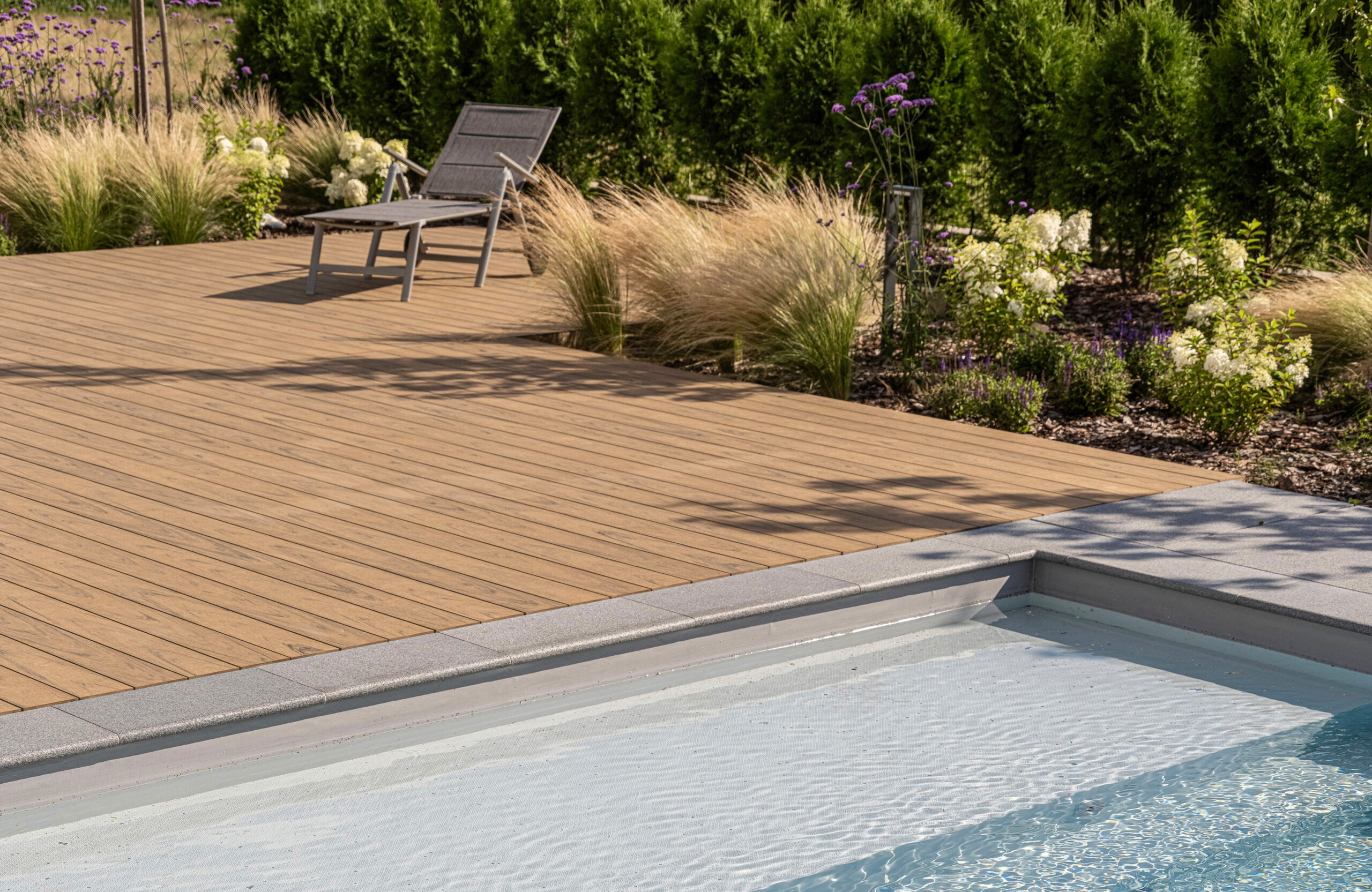 Modern outdoor terrace and pool area finished with BRUGGAN Multicolor sand decking
