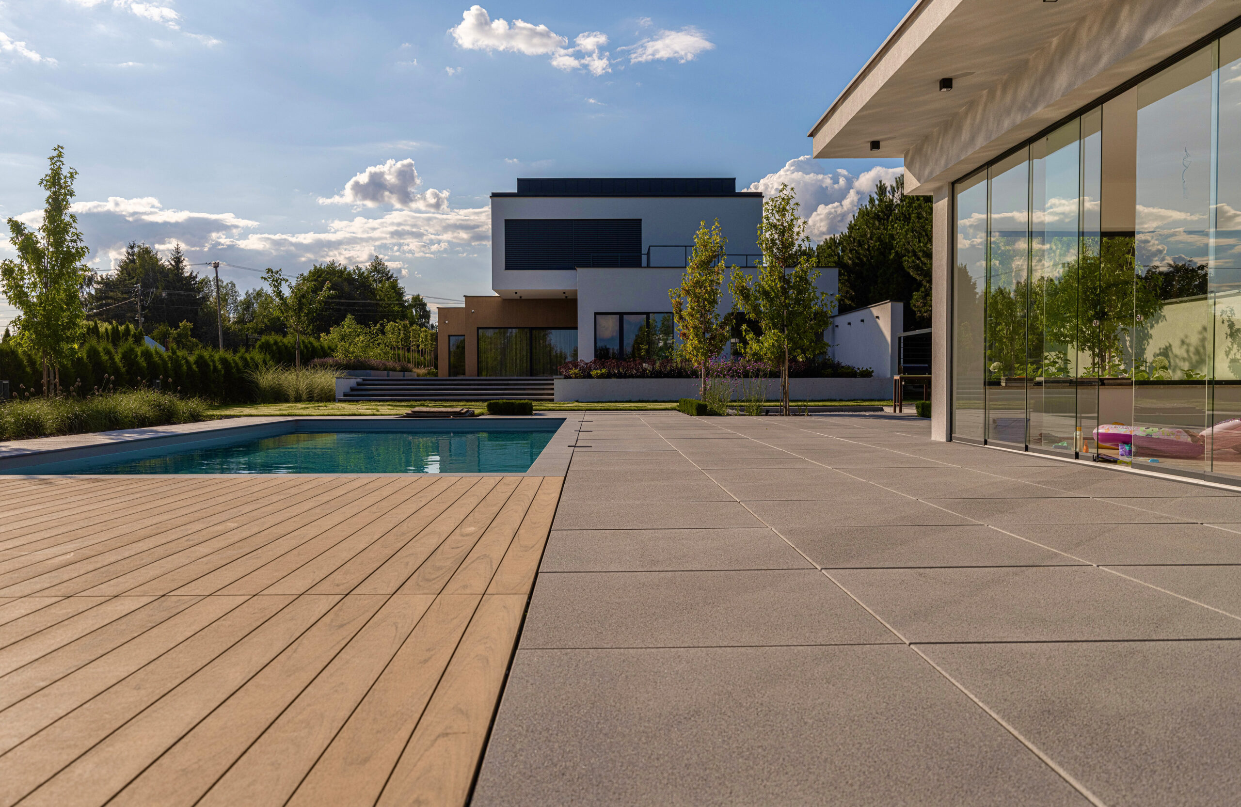 Modern outdoor terrace and pool area finished with BRUGGAN Multicolor sand decking
