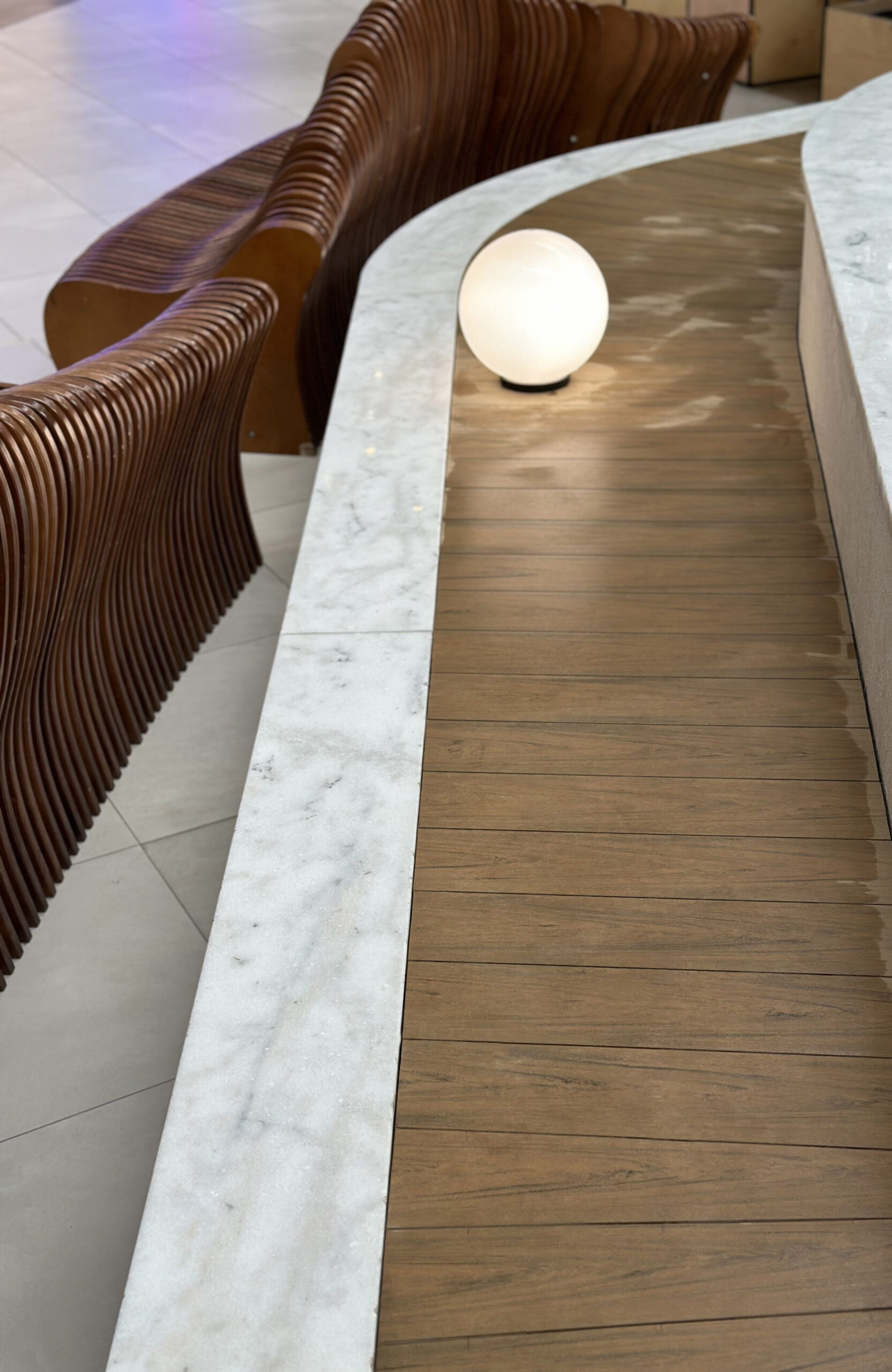 BRUGGAN Multicolor Sand WPC decking used for a curved fountain area in a shopping mall