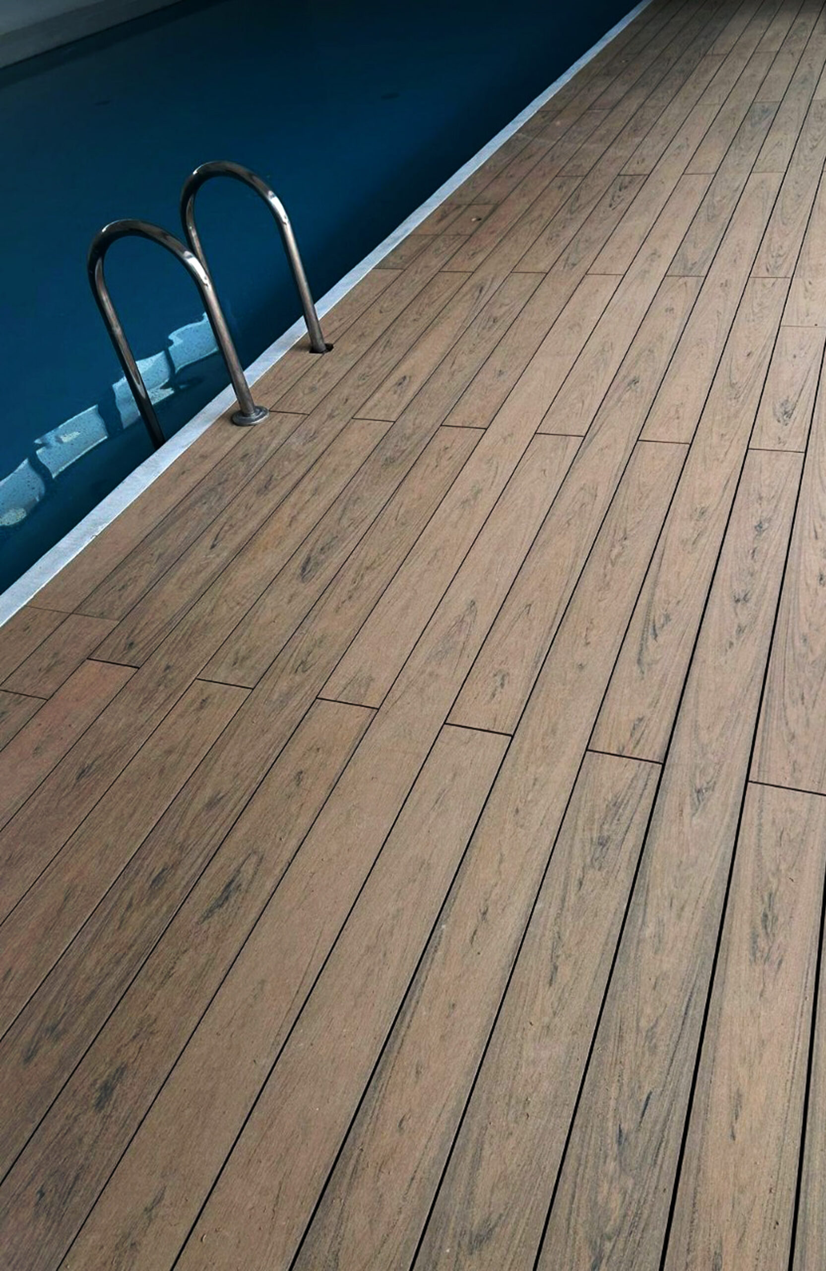 Indoor pool area finished with BRUGGAN Multicolor composite decking in sand color.
