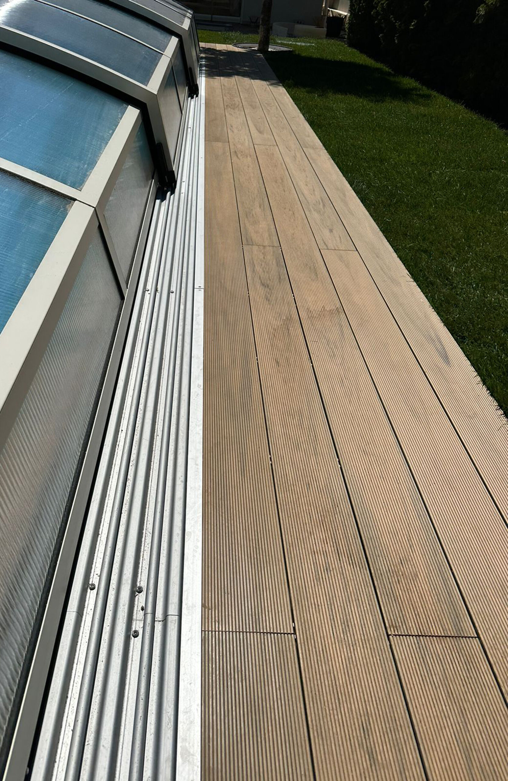 Outdoor pool area finished with BRUGGAN Multicolor decking in sand color