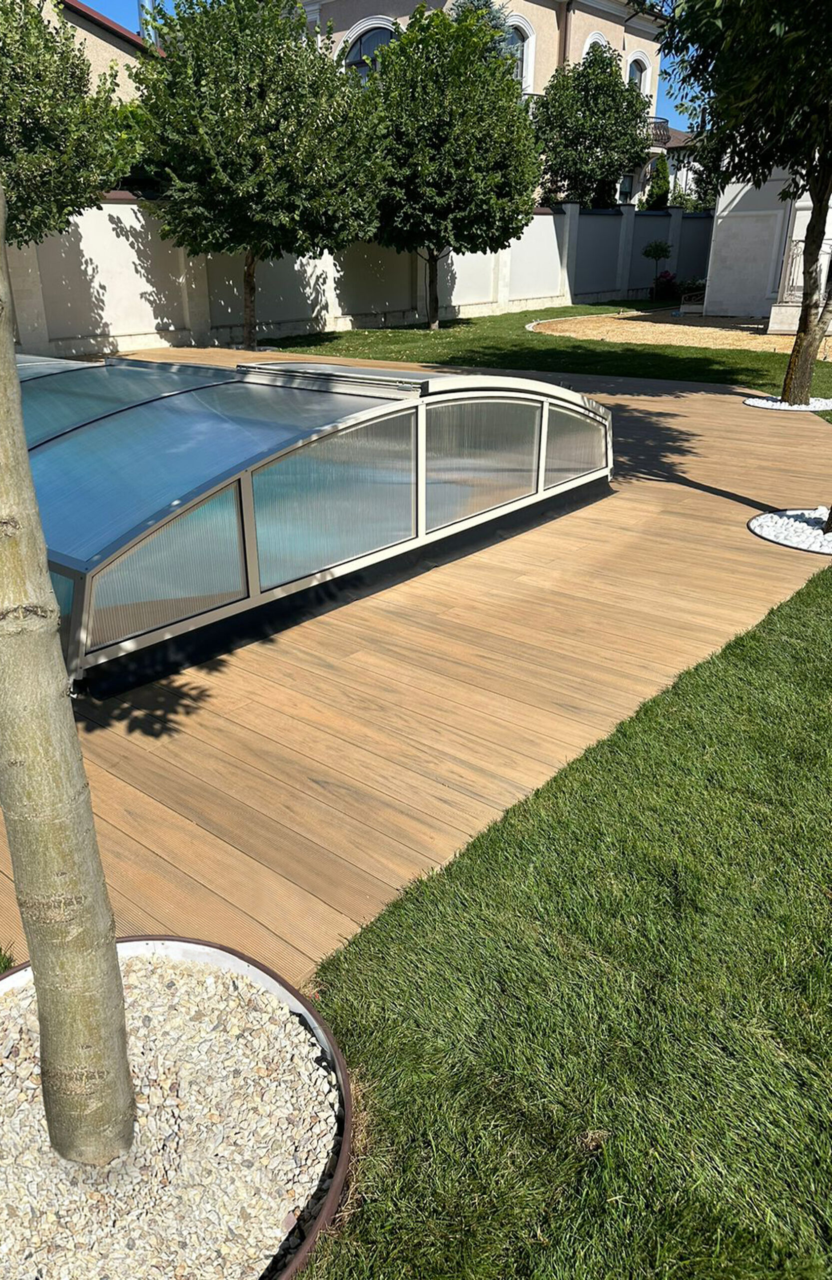 Outdoor pool area finished with BRUGGAN Multicolor decking in sand color