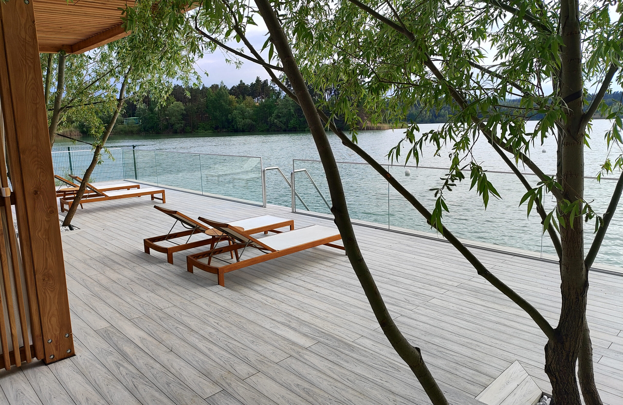 Beach terrace with Smoke White composite decking, sun loungers and lake view