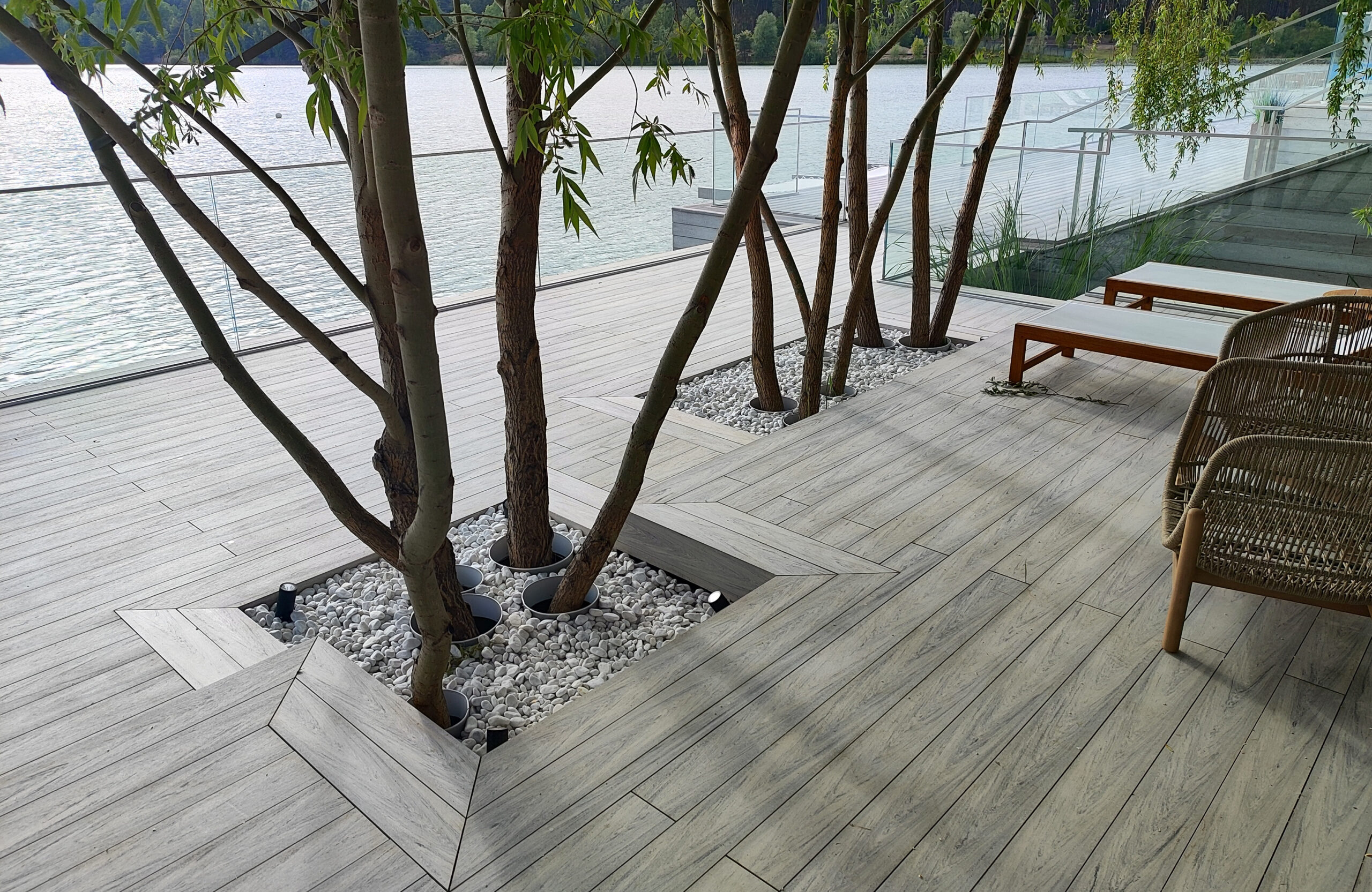 Beach terrace with Smoke White composite decking, sun loungers and lake view