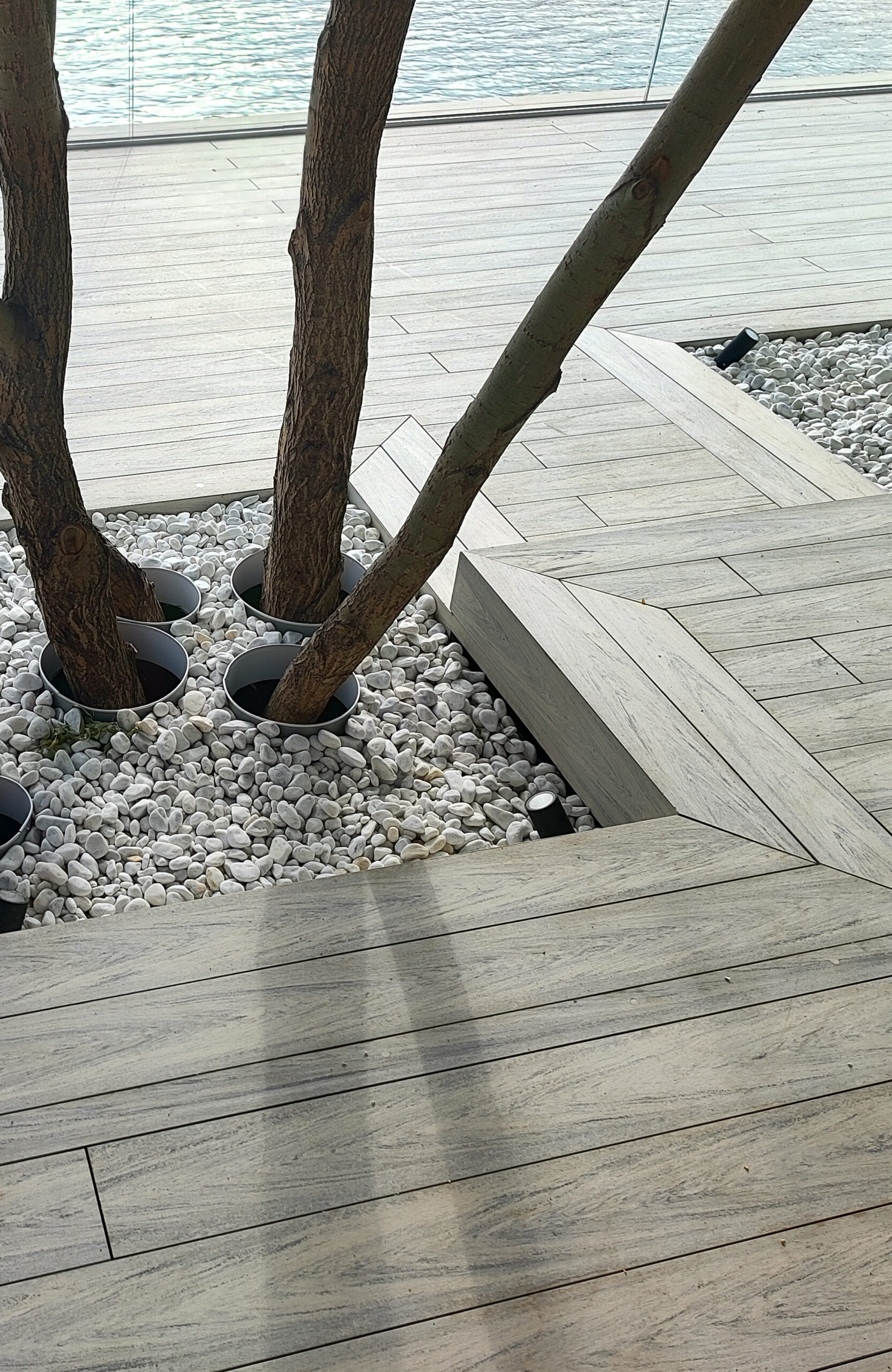 Beach terrace with Smoke White composite decking, sun loungers and lake view