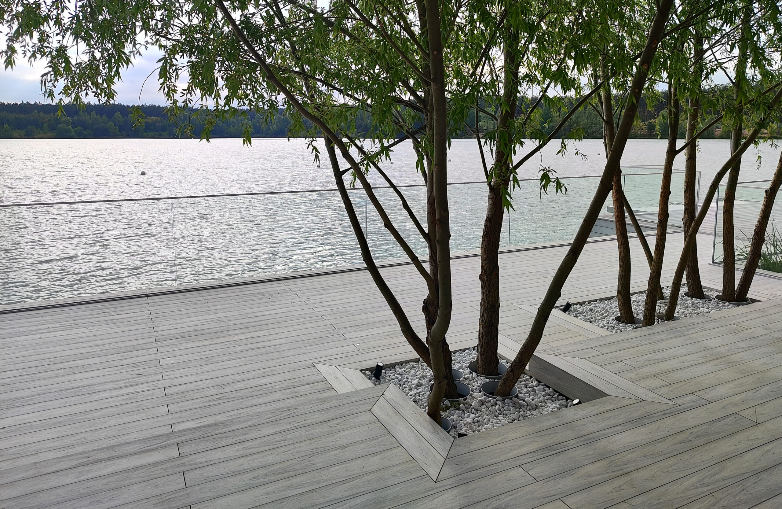Beach terrace with Smoke White composite decking, sun loungers and lake view