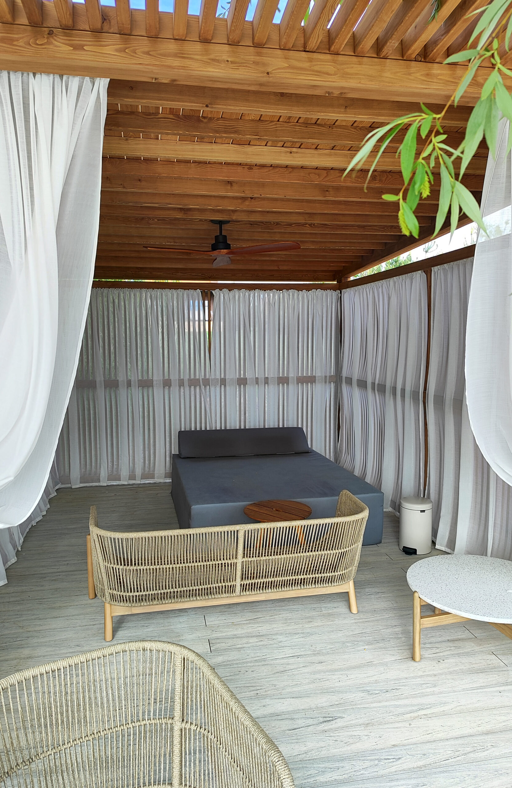 Modern lakeside terrace with light composite decking, lounge areas and glass railing