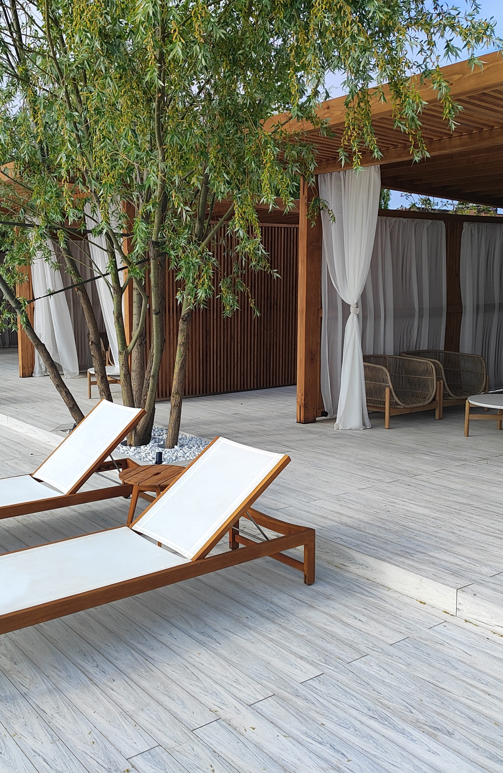 Beach terrace with Smoke White composite decking, sun loungers and lake view