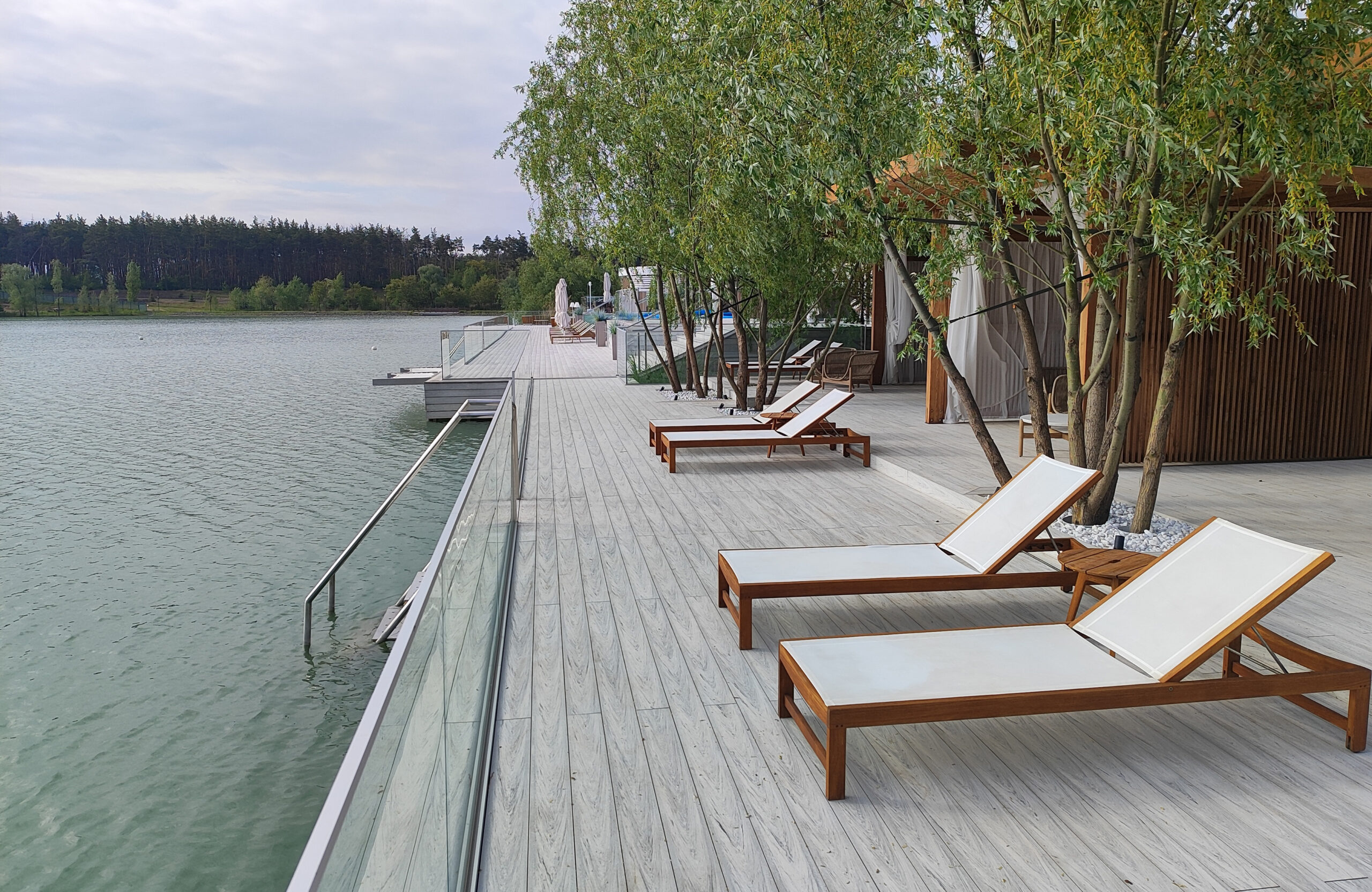 Beach terrace with Smoke White composite decking, sun loungers and lake view