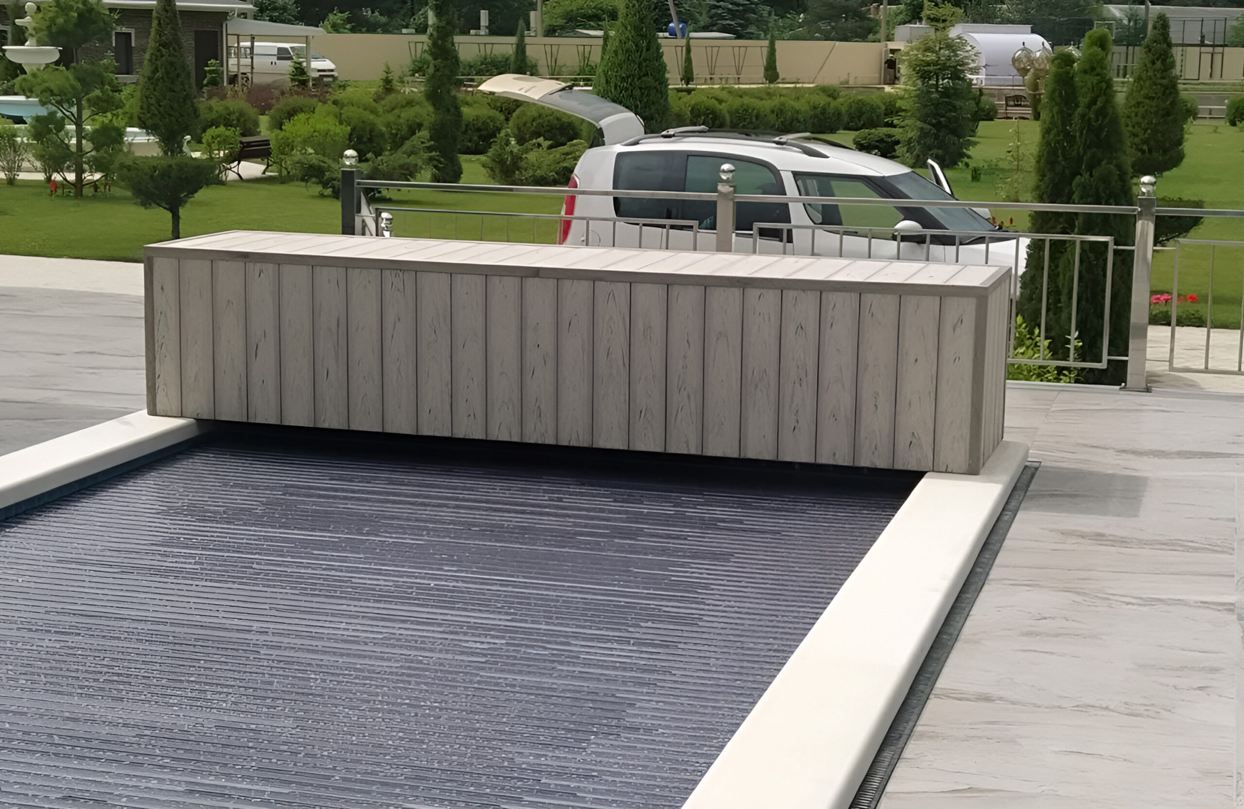 Light wood-effect BRUGGAN decking used for a spacious terrace and pool surround