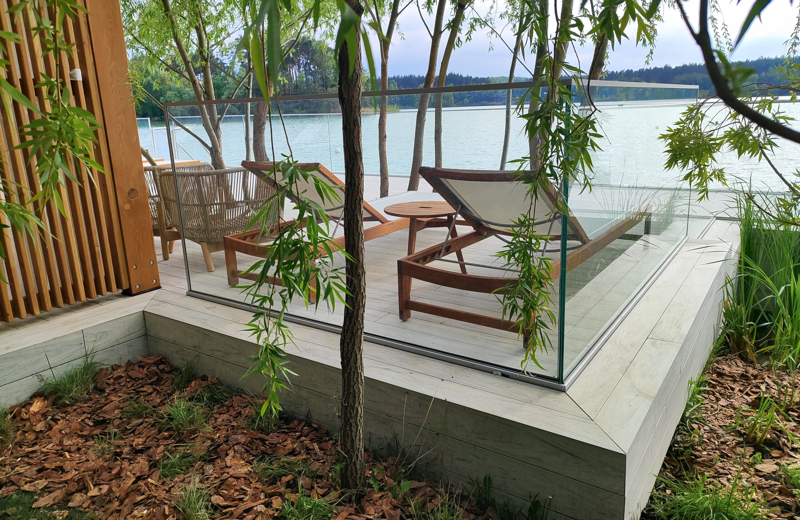 Beach terrace with Smoke White composite decking, sun loungers and lake view
