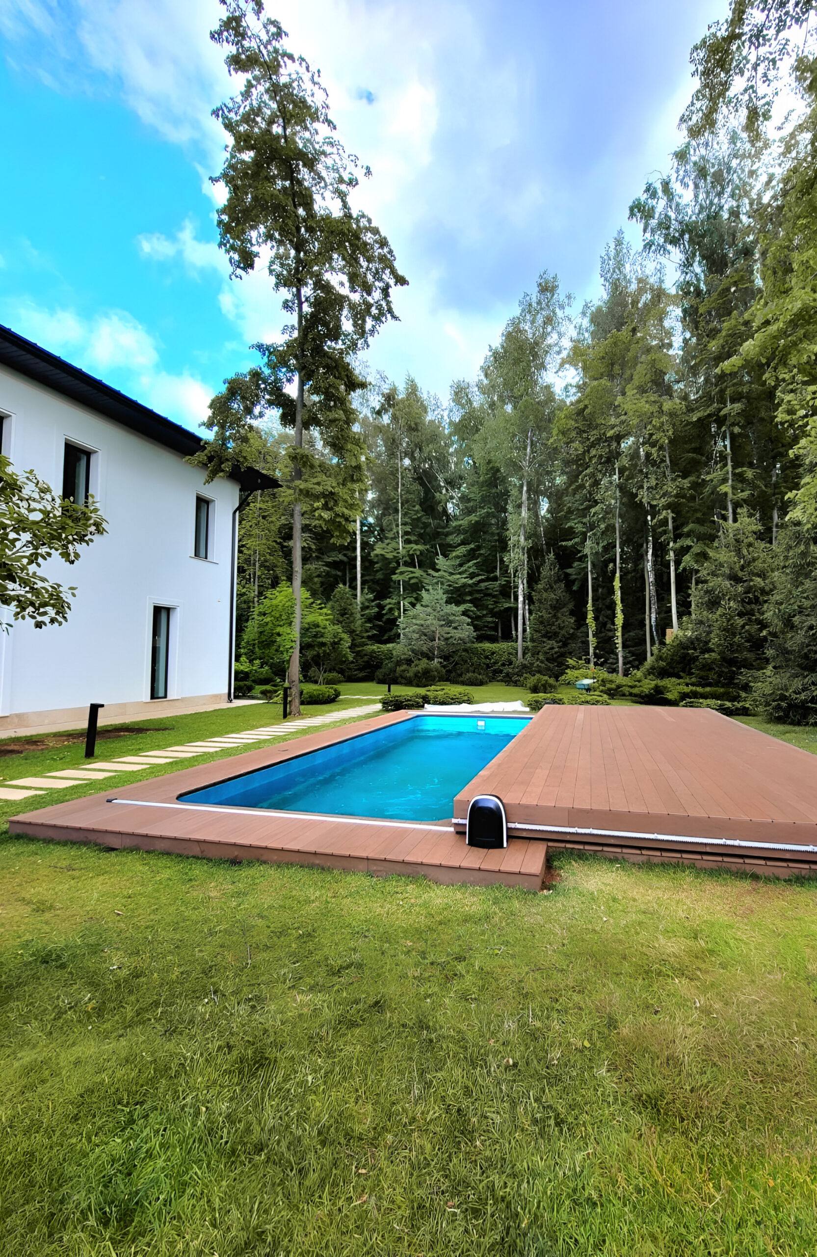 Private garden swimming pool with BRUGGAN Multicolor Wenge decking and sliding pool cover