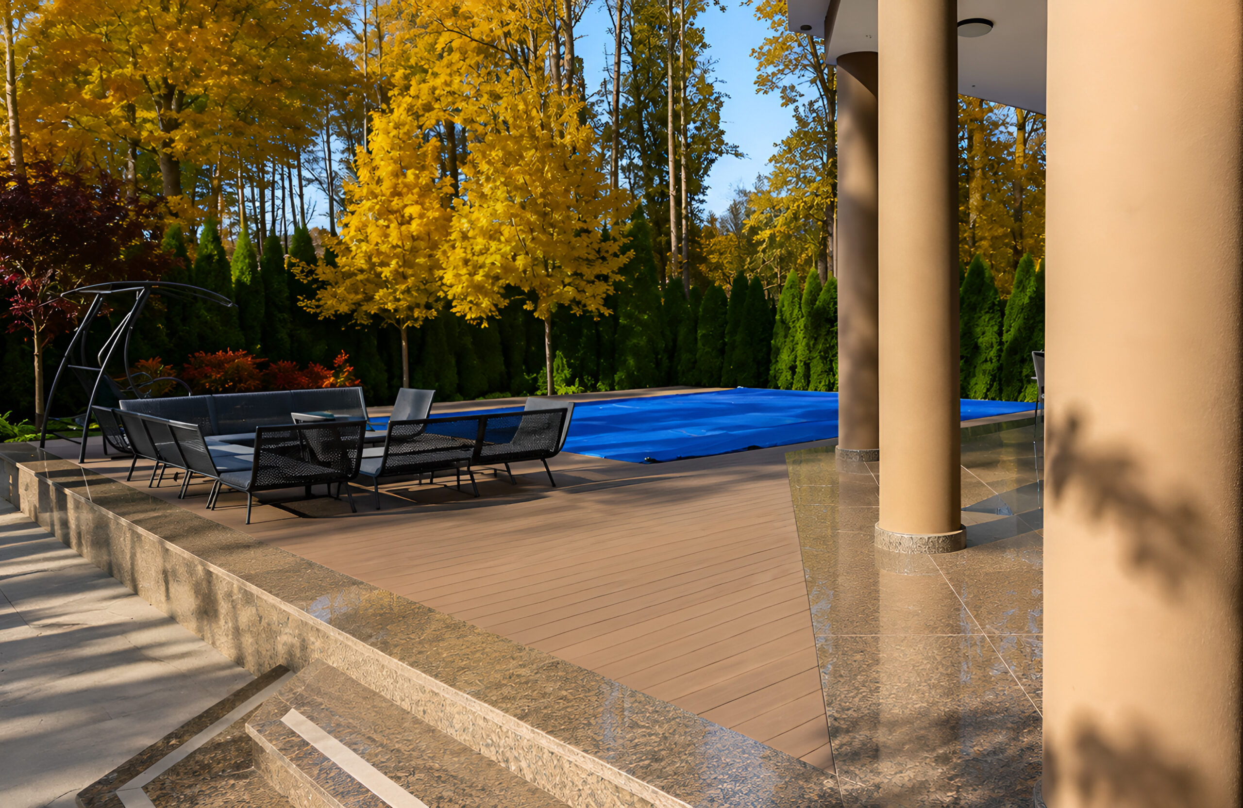 BRUGGAN Multicolor Wenge composite decking around a private swimming pool and outdoor lounge area