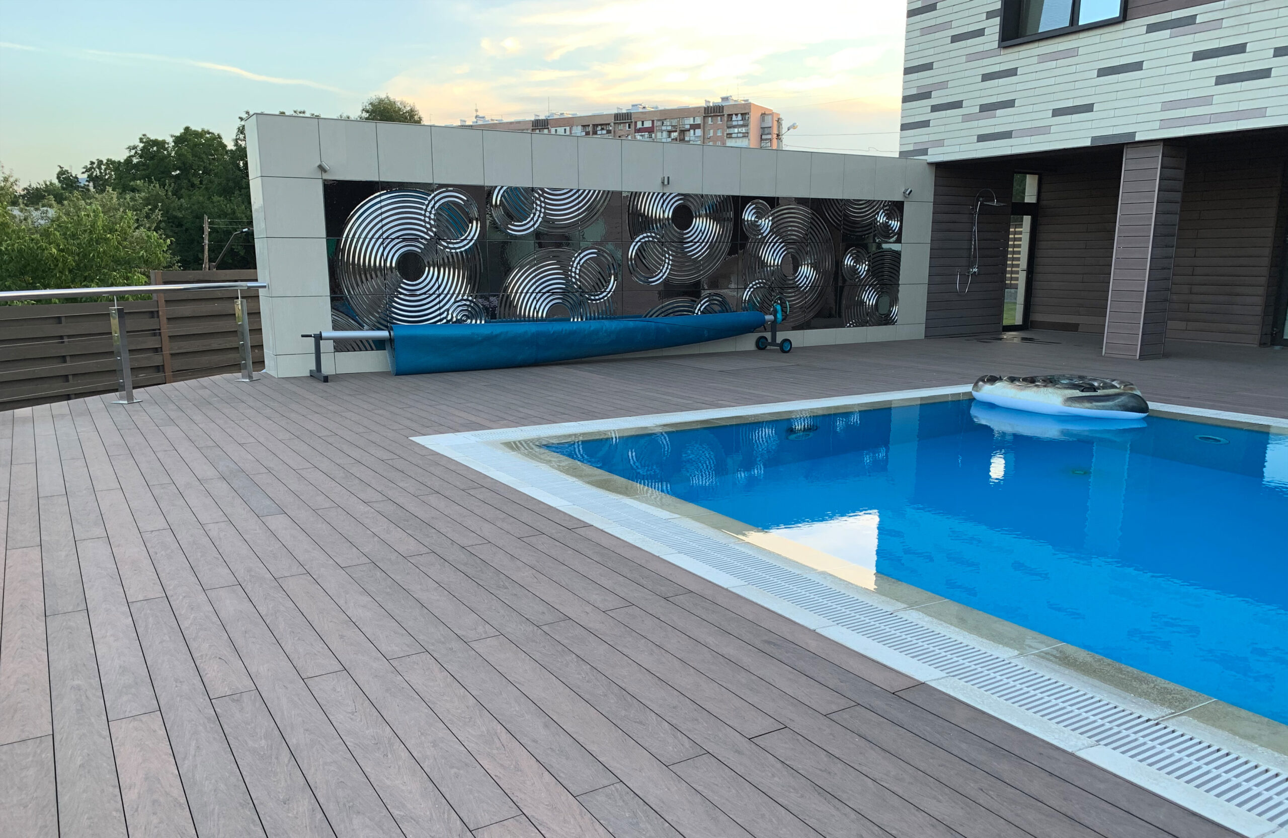 Modern pool terrace finished with BRUGGAN Multicolor Wenge decking at a private residence