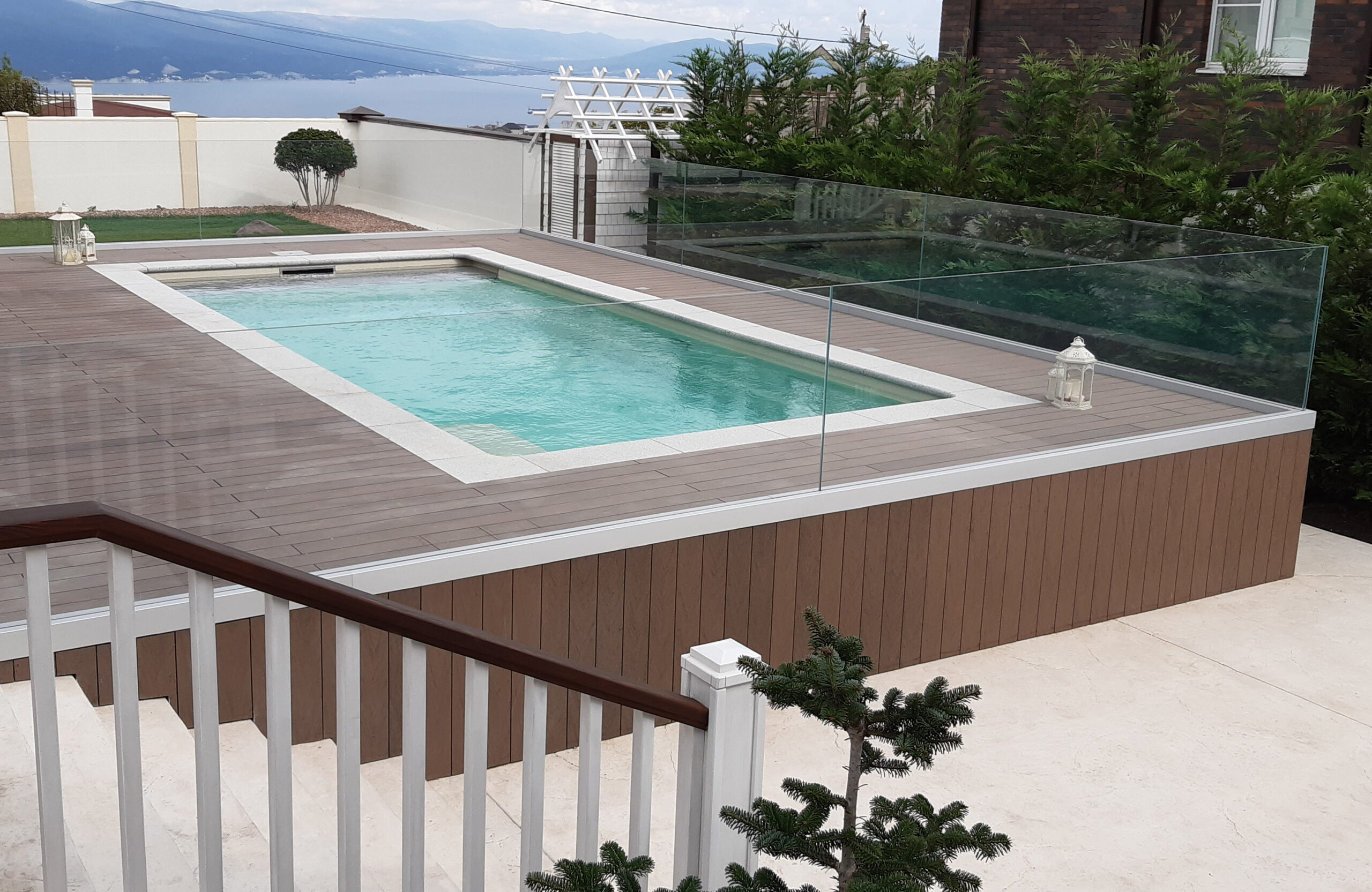 Private swimming pool area finished with BRUGGAN Multicolor Wenge outdoor decking