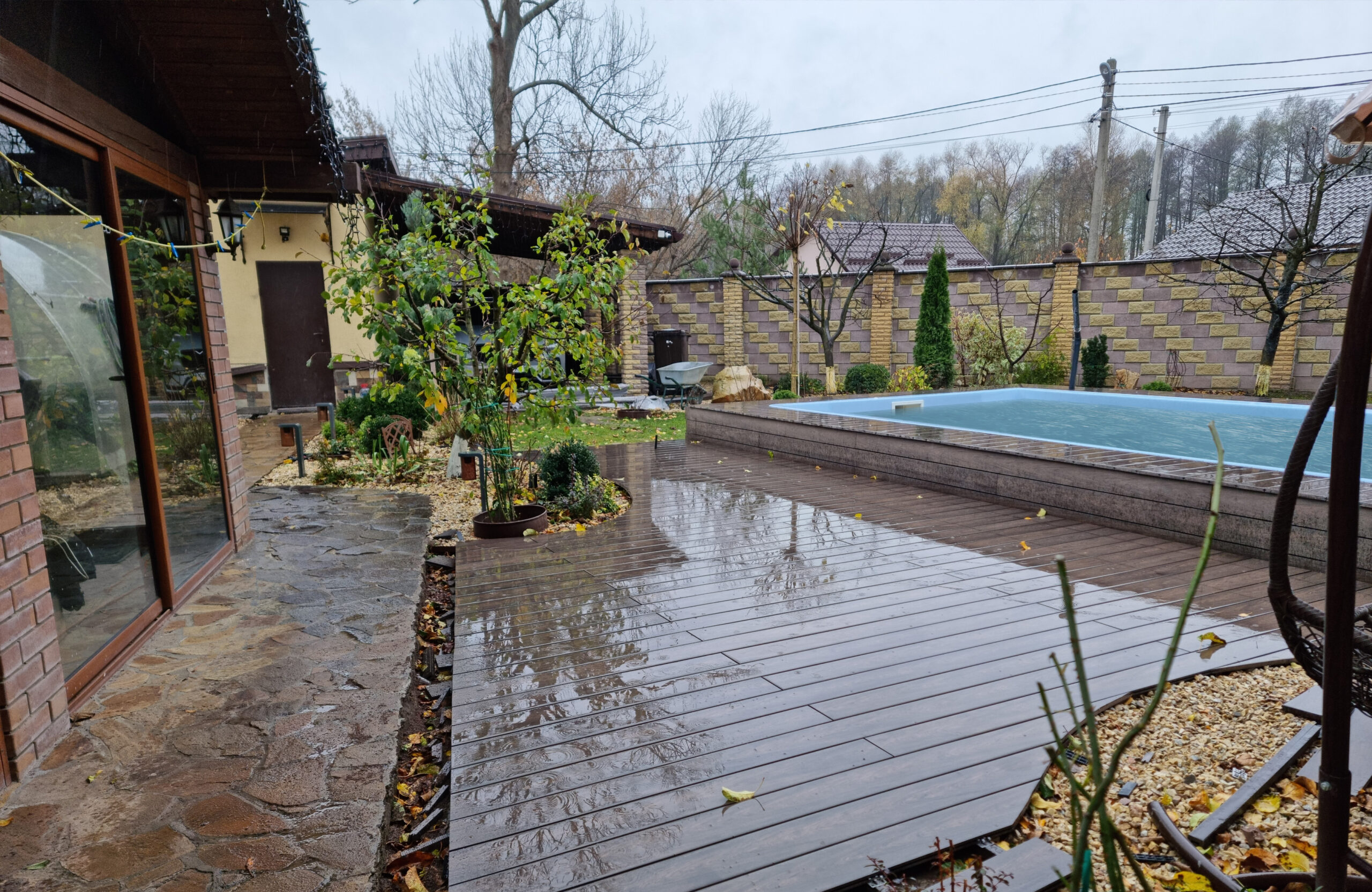 BRUGGAN Multicolor Wenge outdoor decking surrounding a raised swimming pool in a private backyard